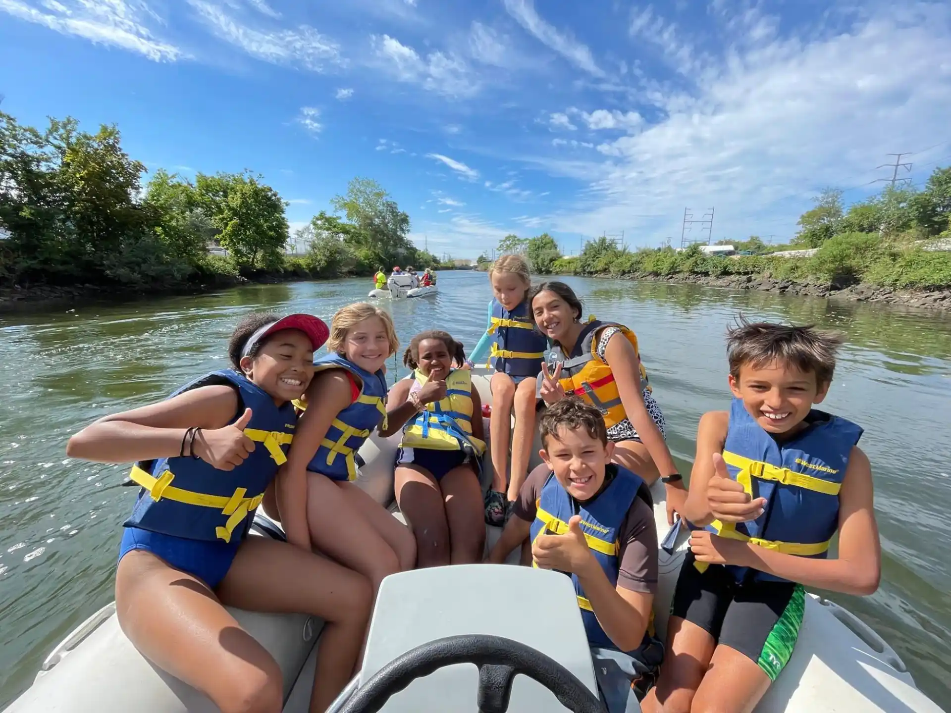 a group of people in life jackets on a boat