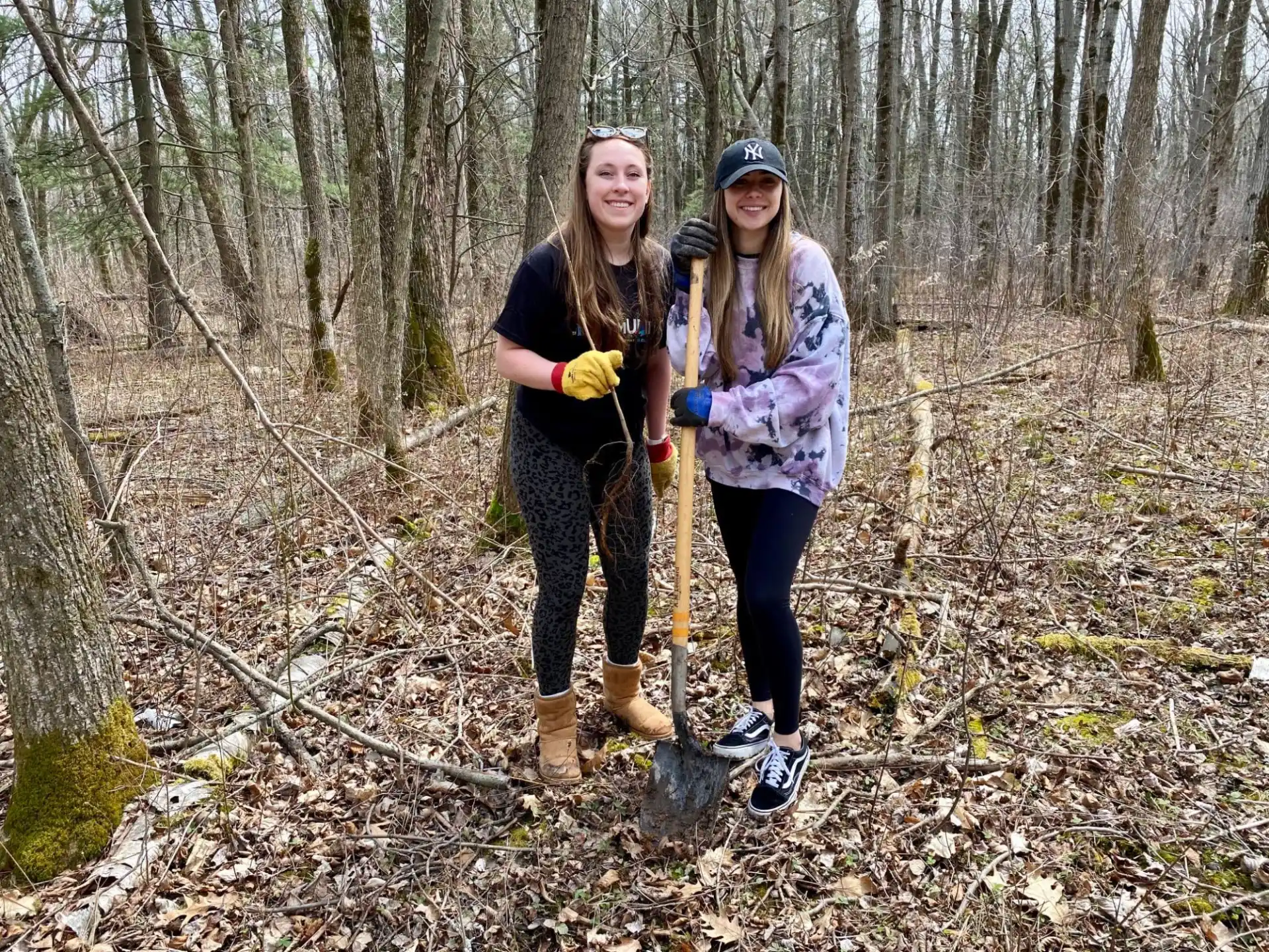 two women standing in the woods