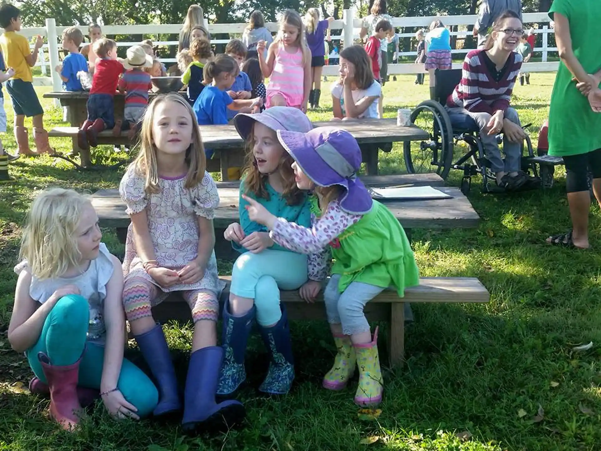 a group of girls sitting on a bench