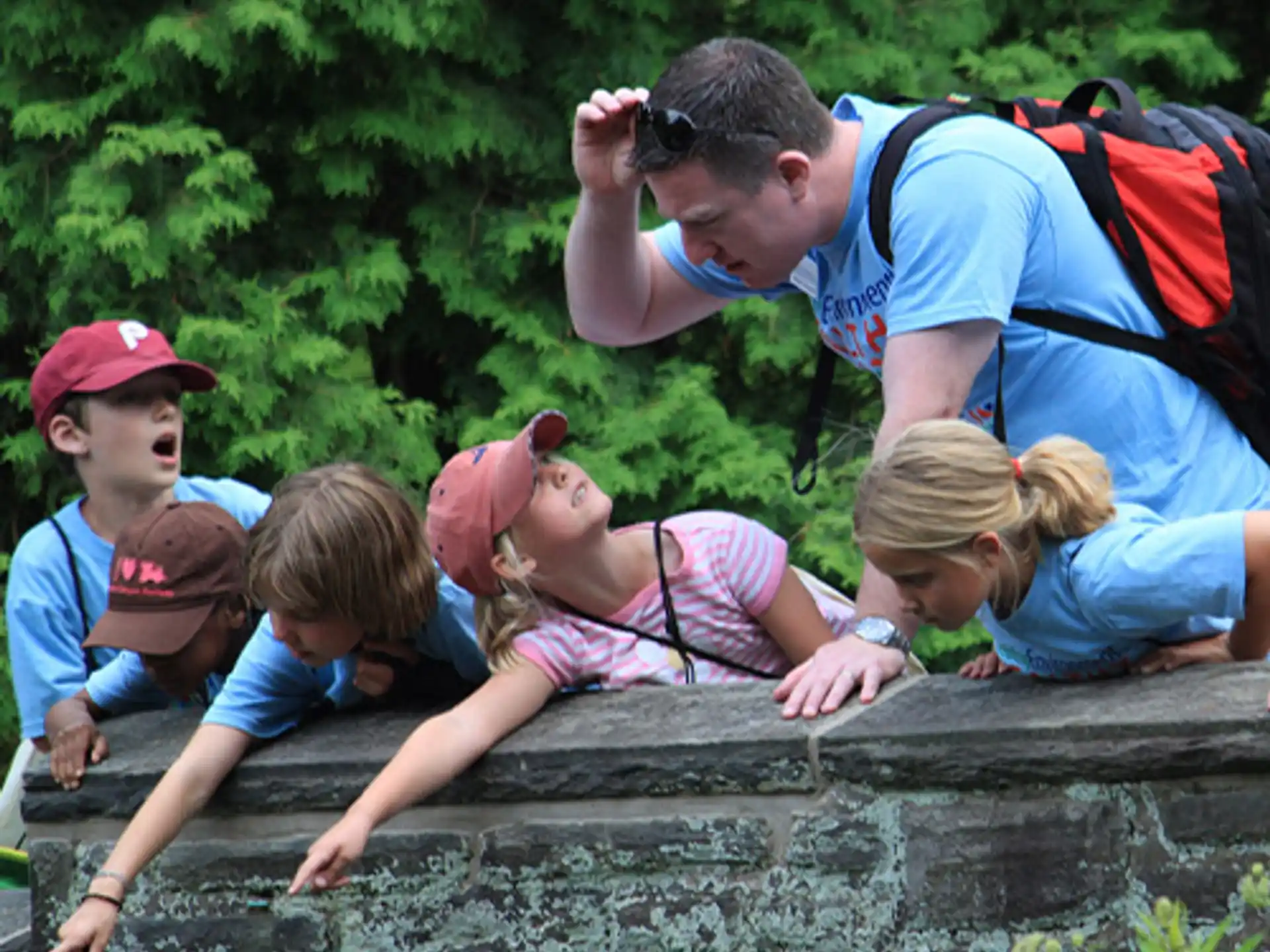 a man taking a picture of a group of kids