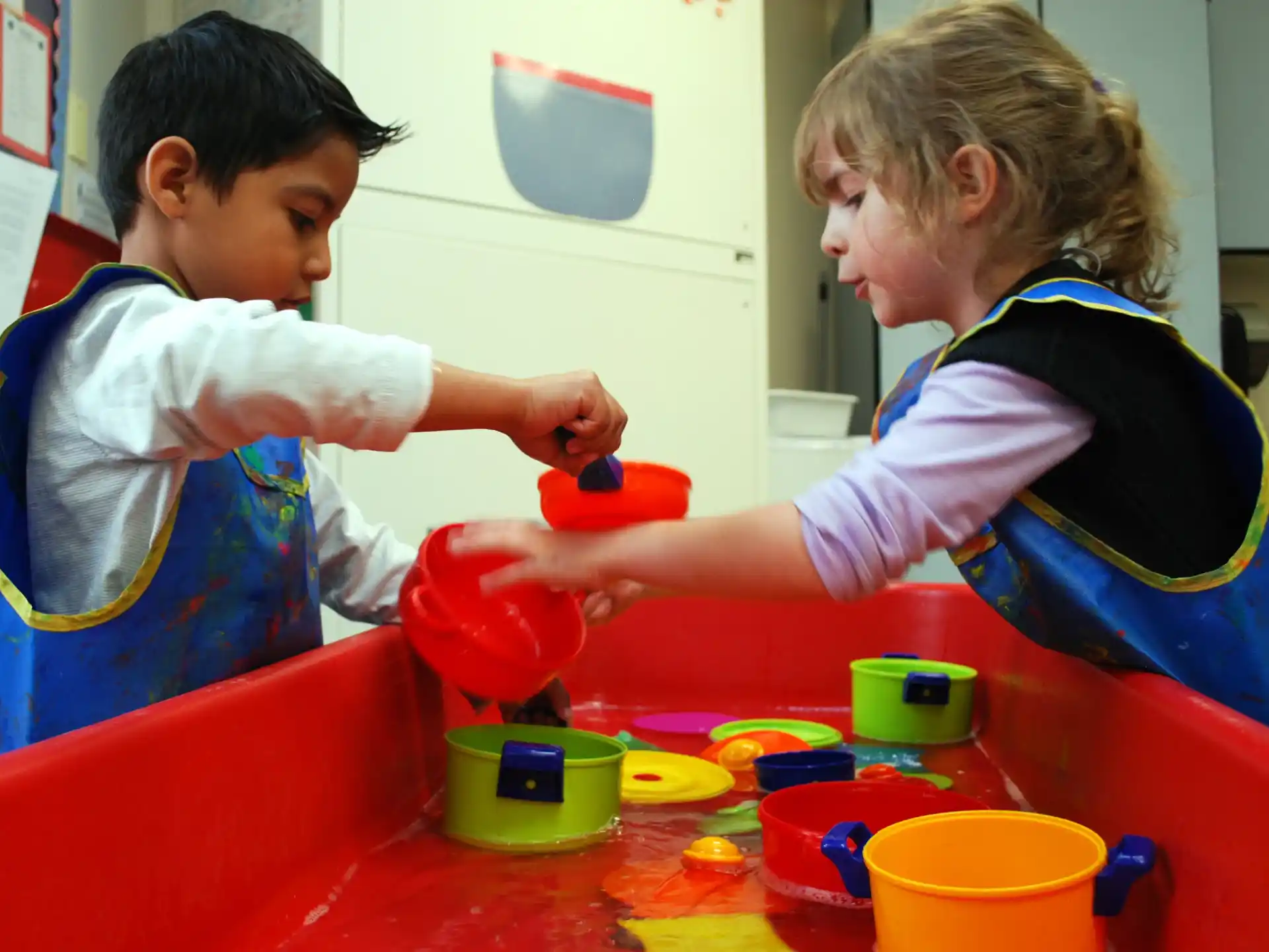 a young boy and girl painting
