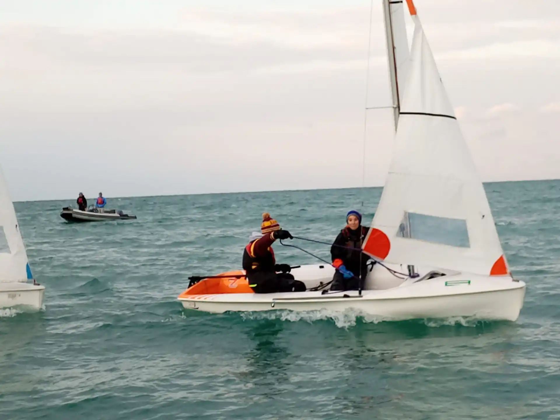 a group of people on a sailboat in the water