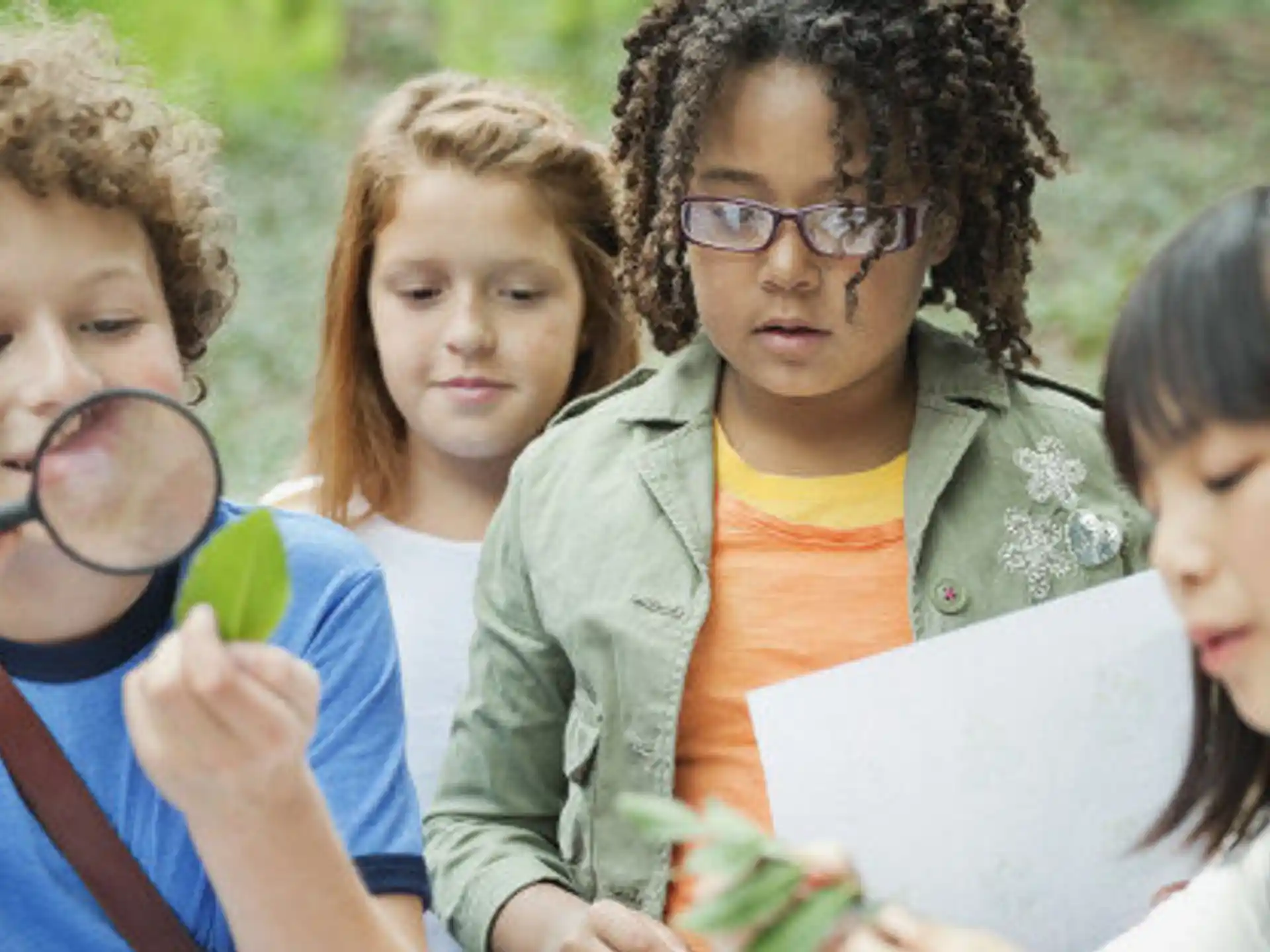 a group of children looking at a paper