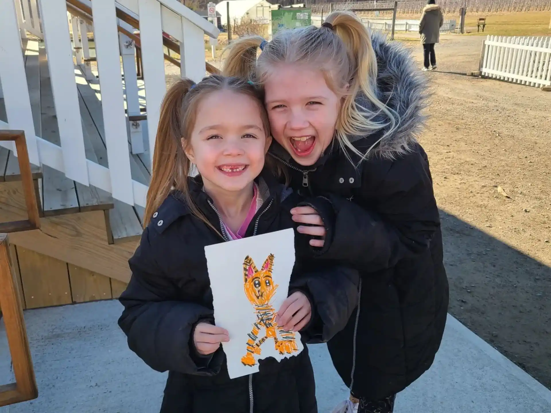 a couple of girls holding a picture