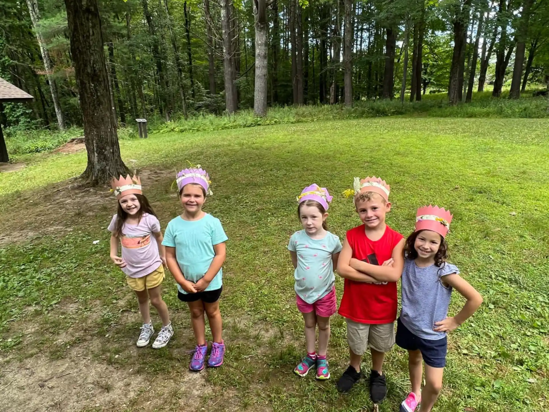 a group of children posing for a photo in a park