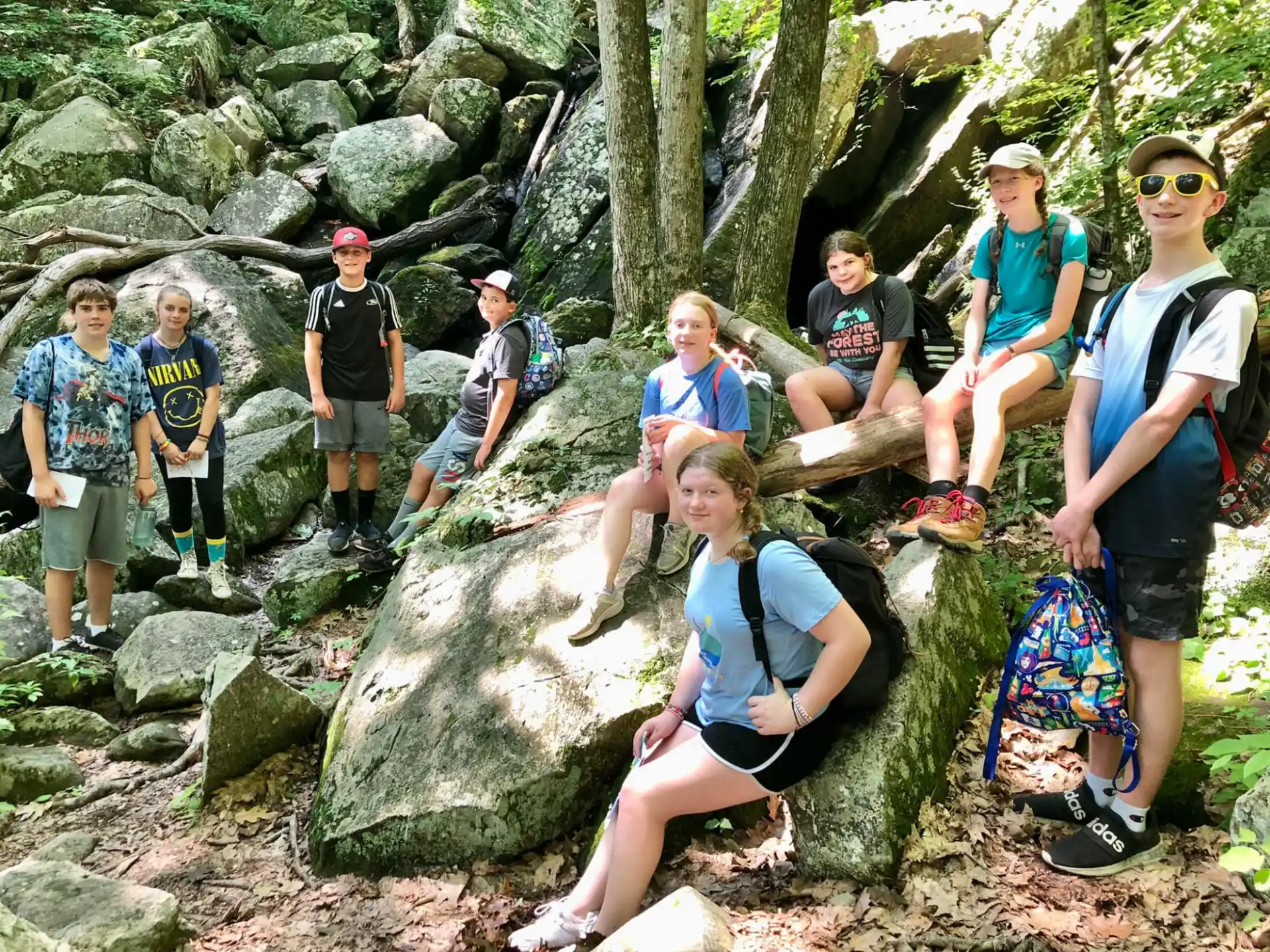 a group of people sitting on rocks