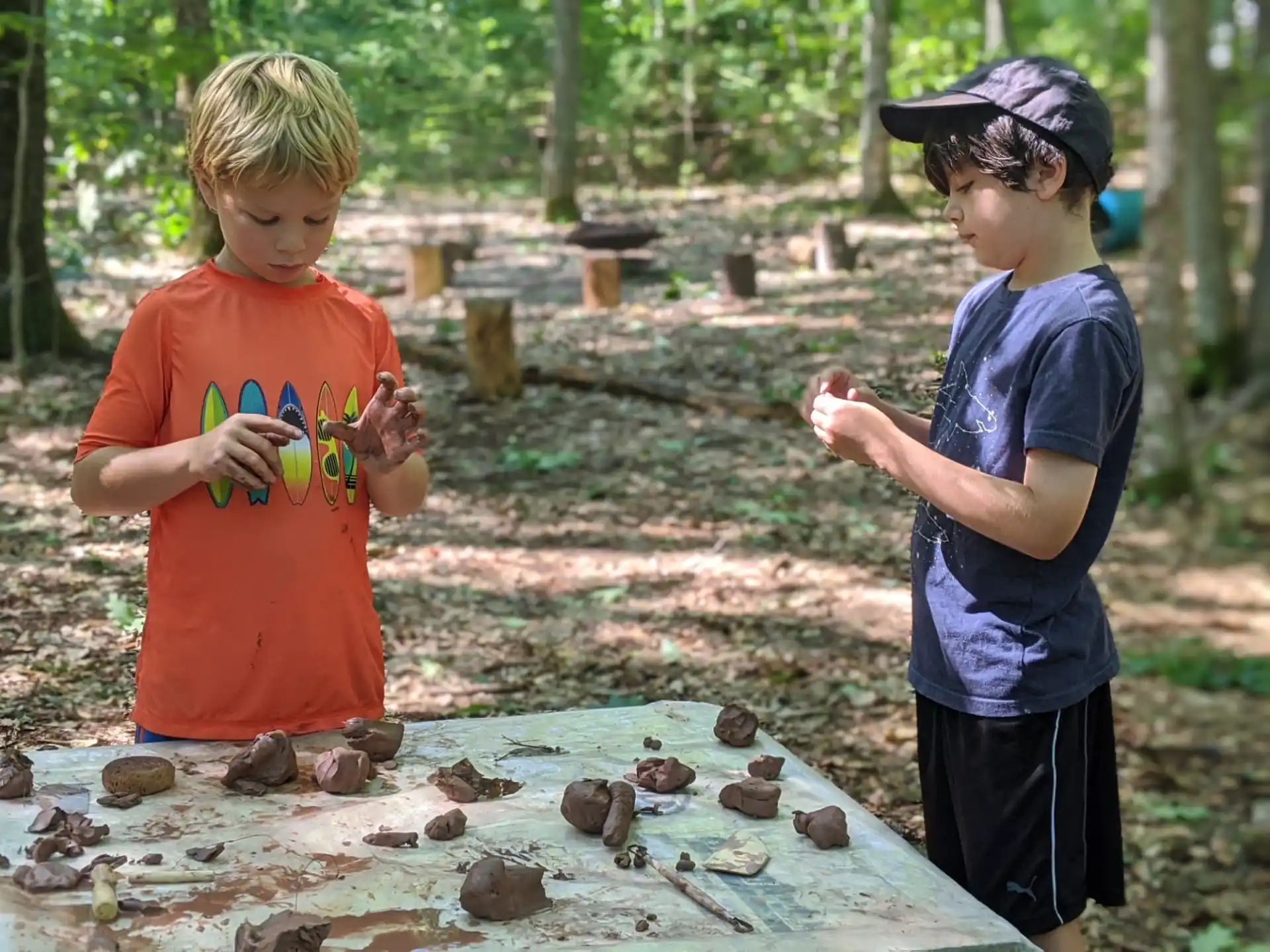 two boys standing next to a pond with turtles