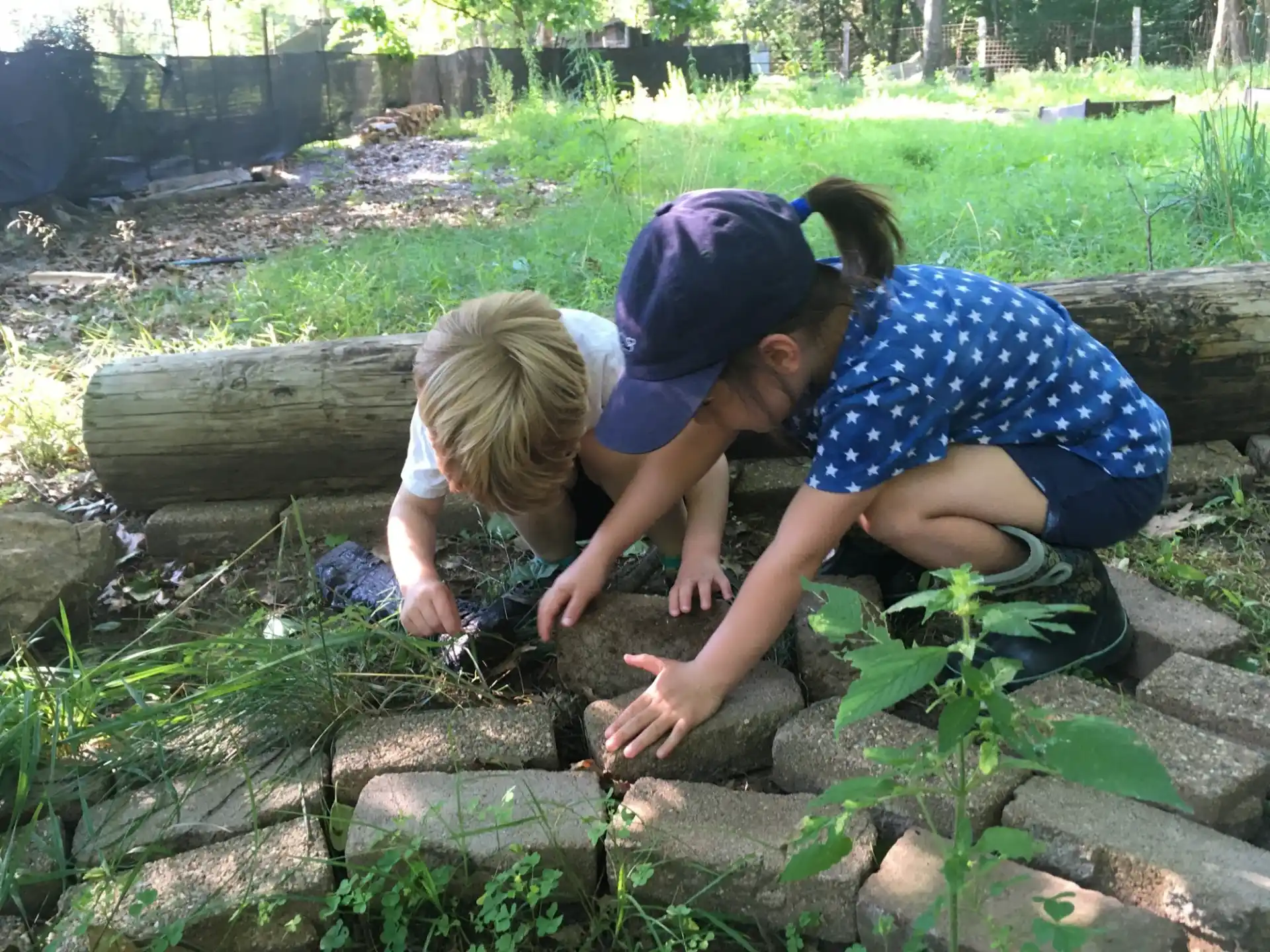 a couple of children playing in the mud
