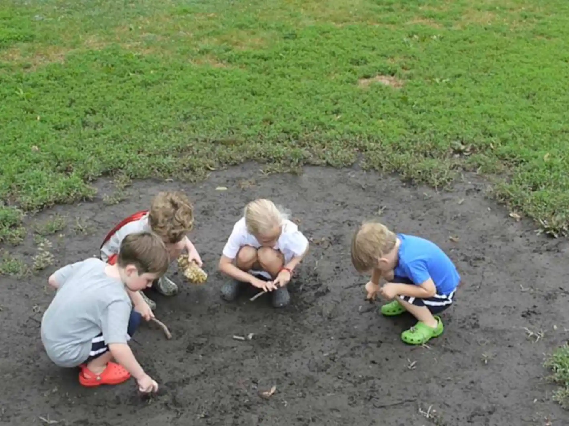 a group of children playing in the dirt