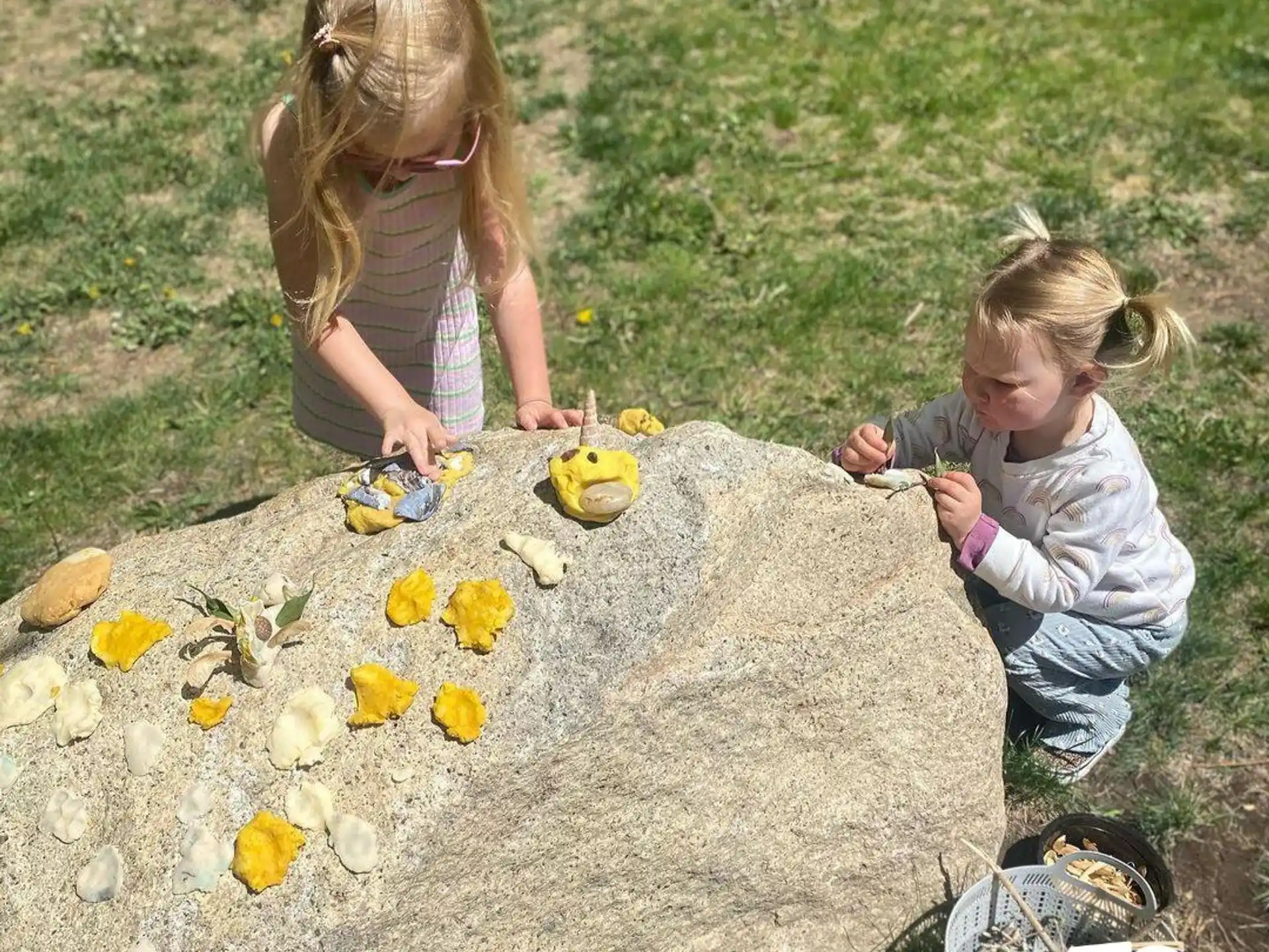 a couple of girls playing in the dirt