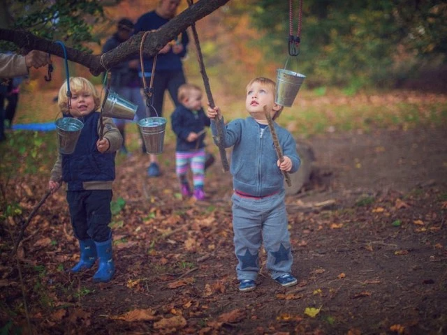 a group of children holding buckets