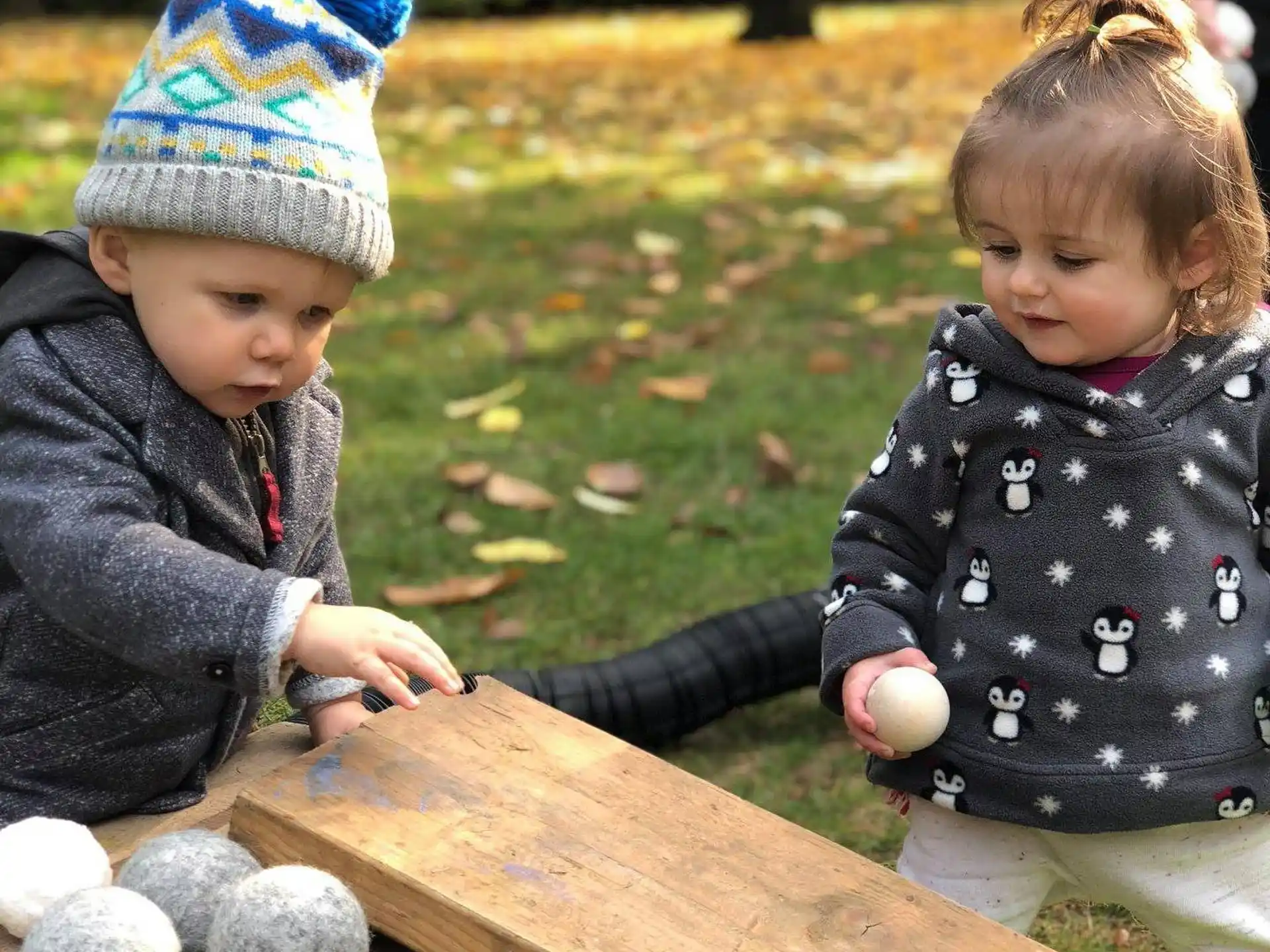 a couple of children playing with rocks