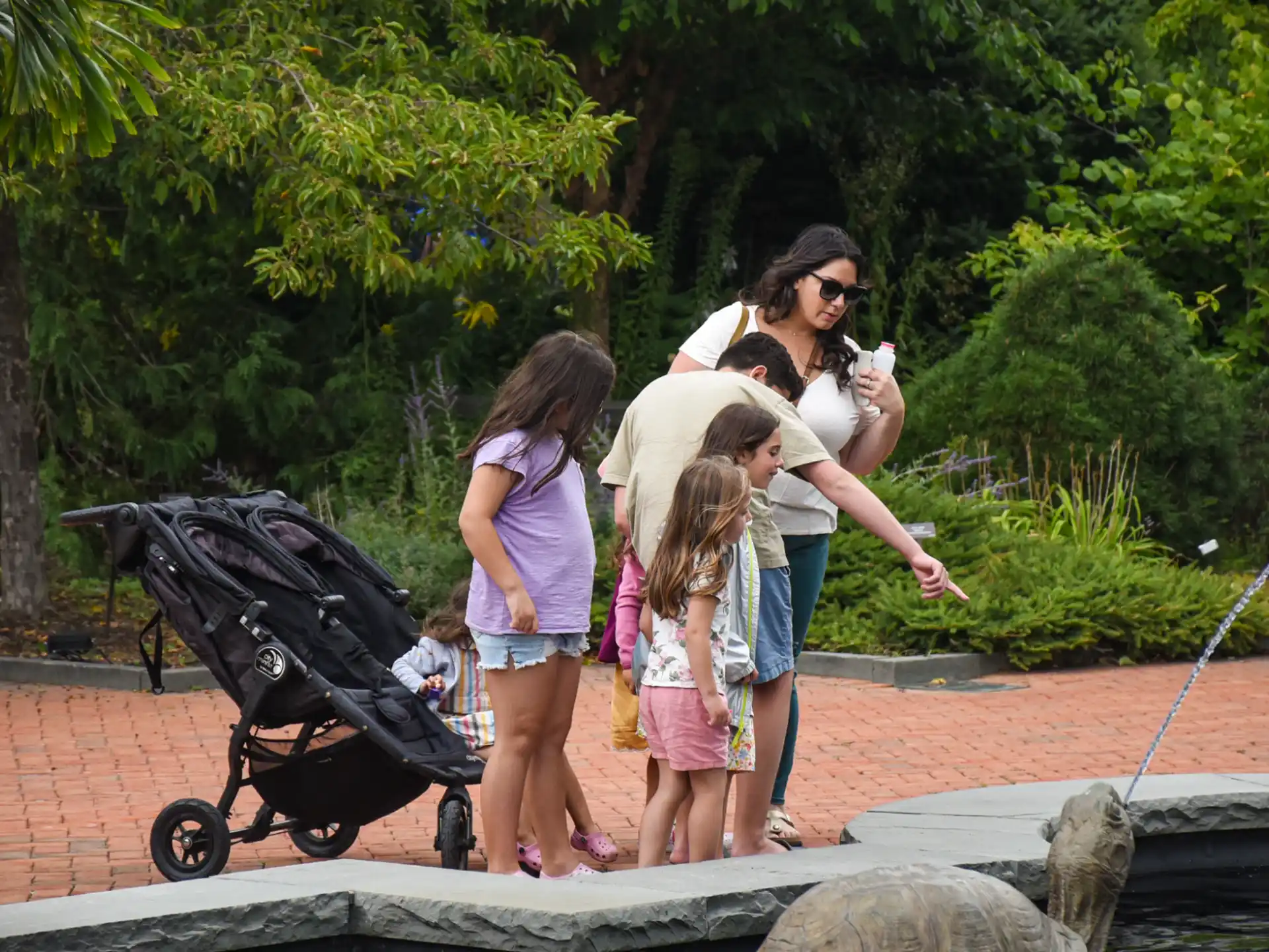 a person and two children walking on a stone path