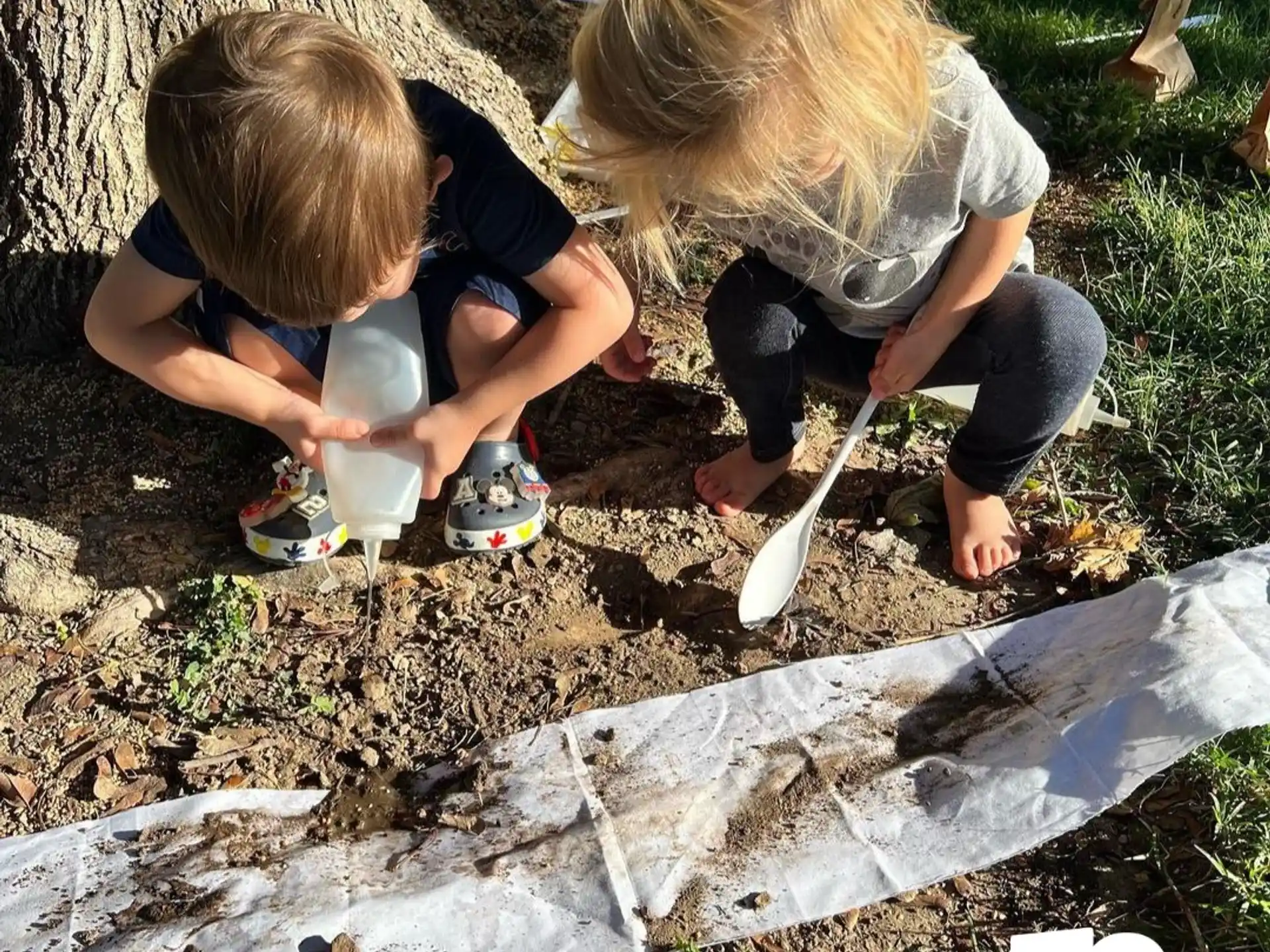 a couple of kids playing in the sand