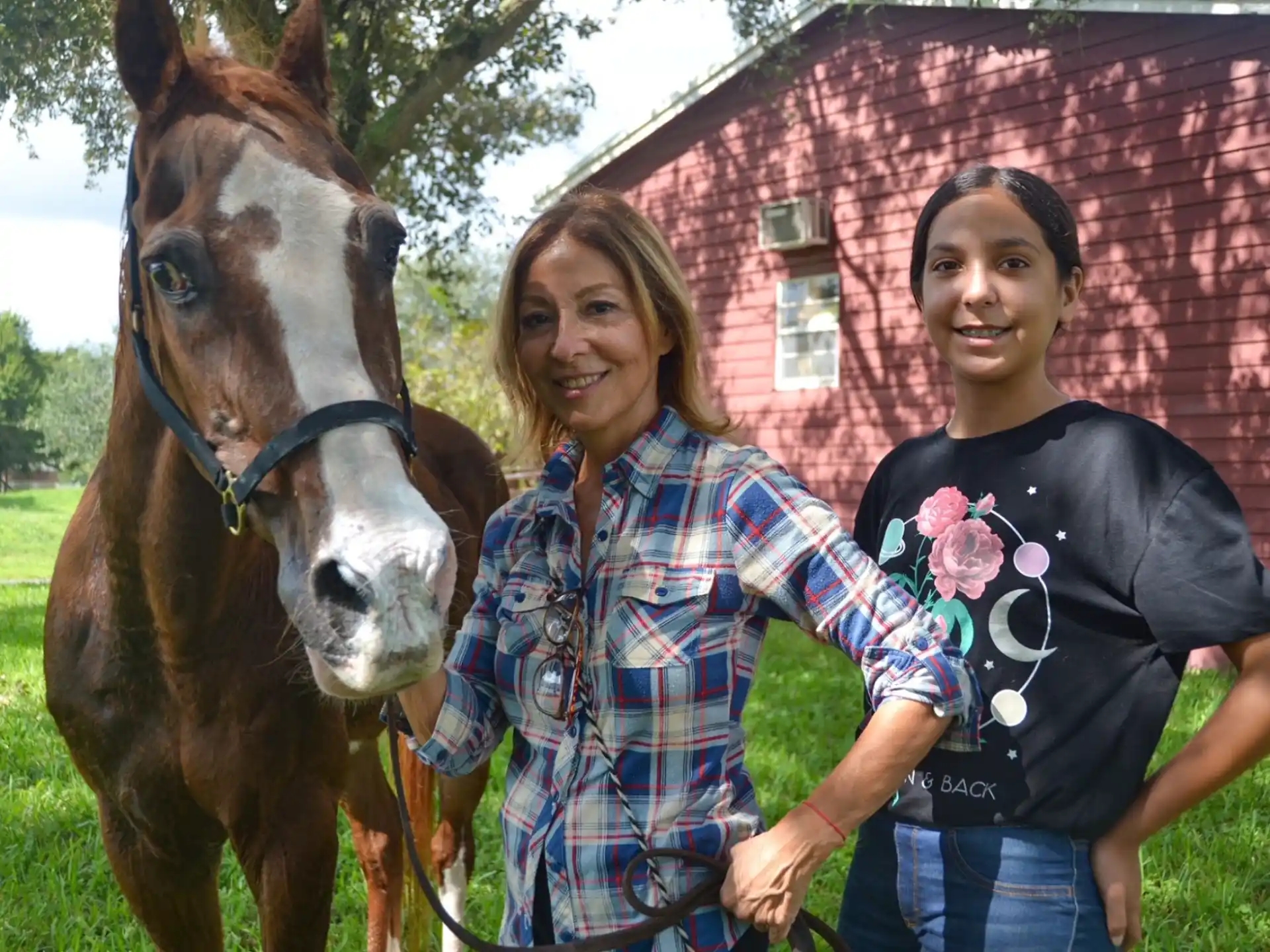 a couple of people posing with a horse