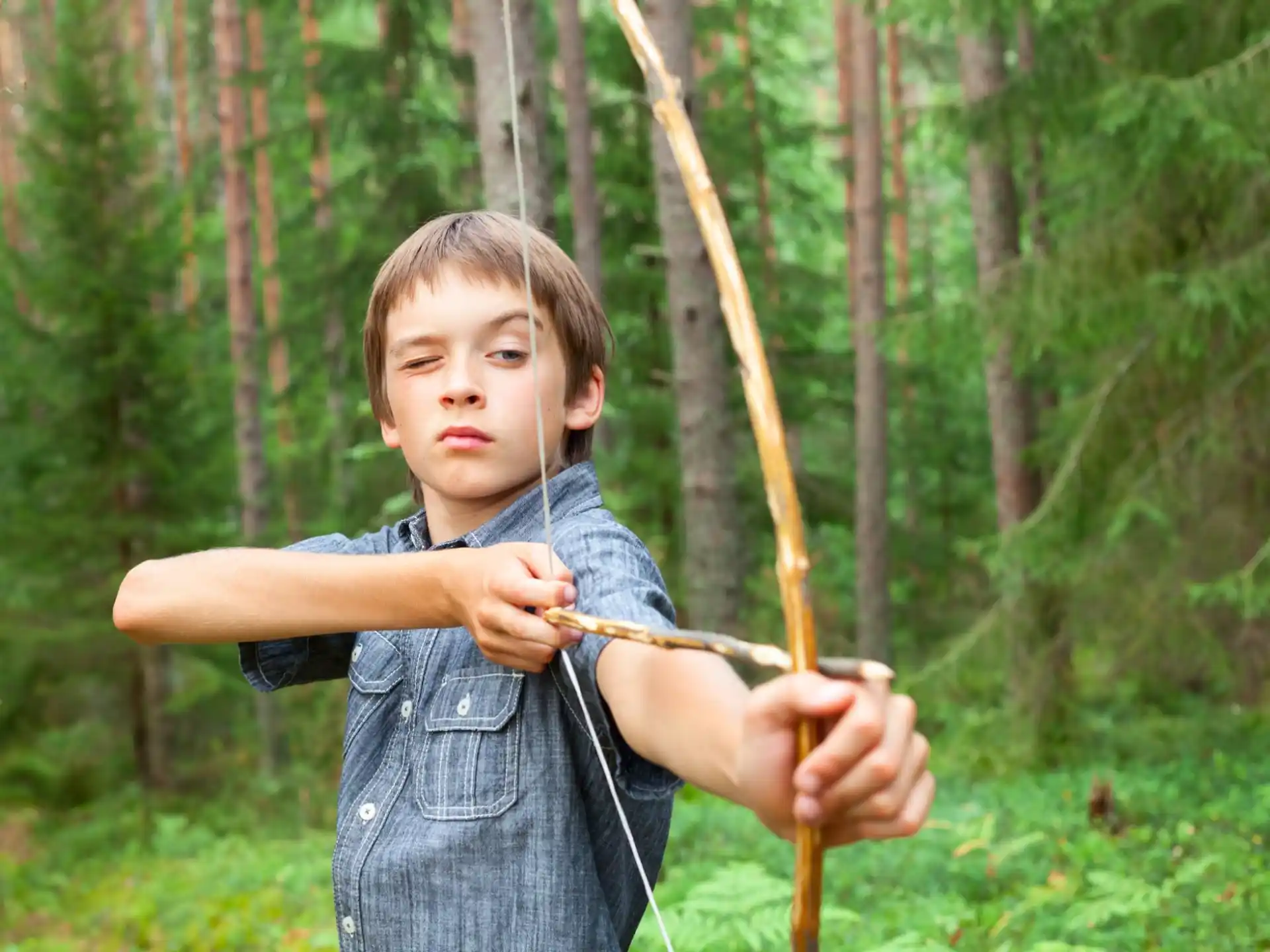 a boy holding a bow and arrow