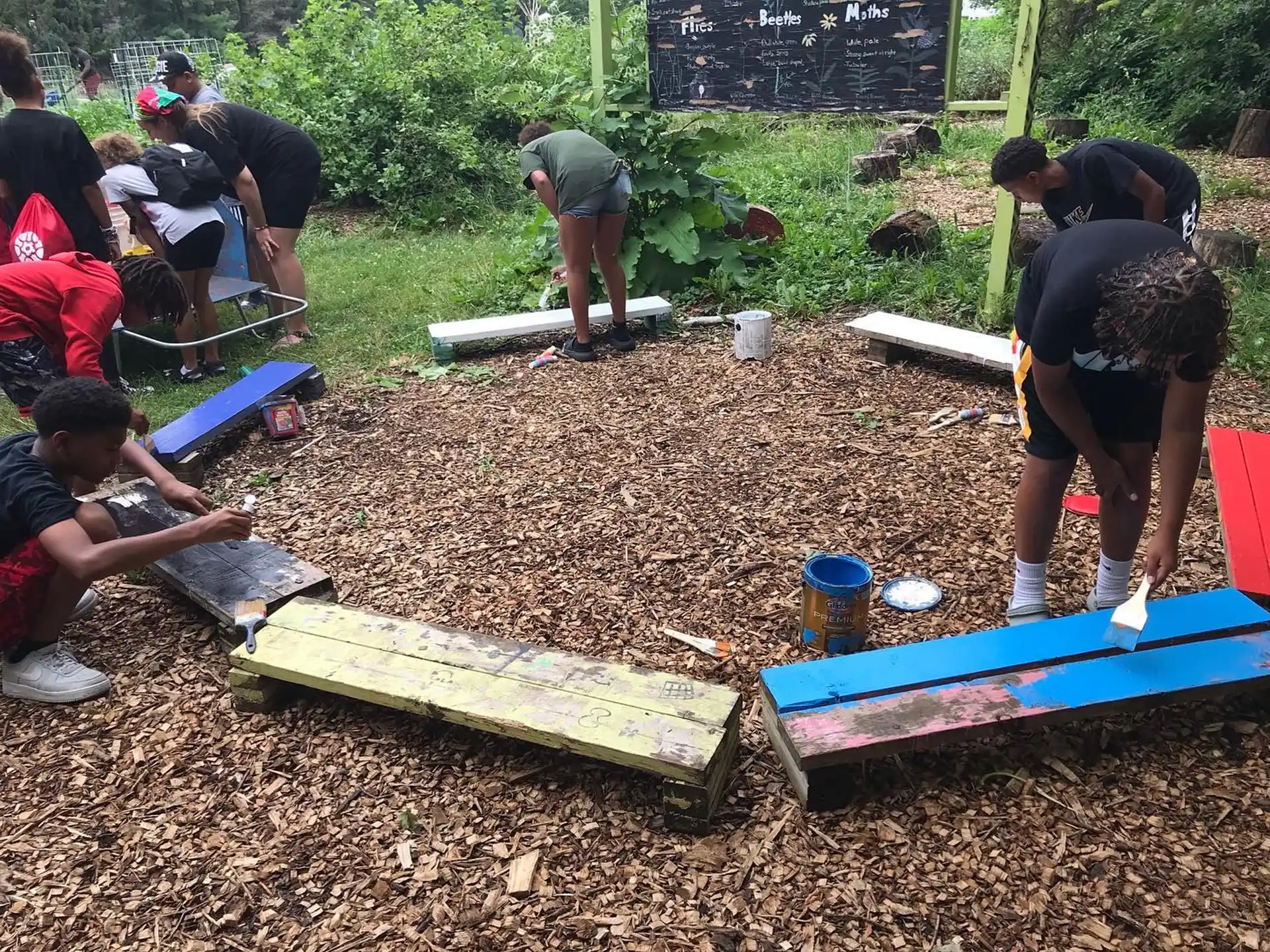 a group of people working on a garden