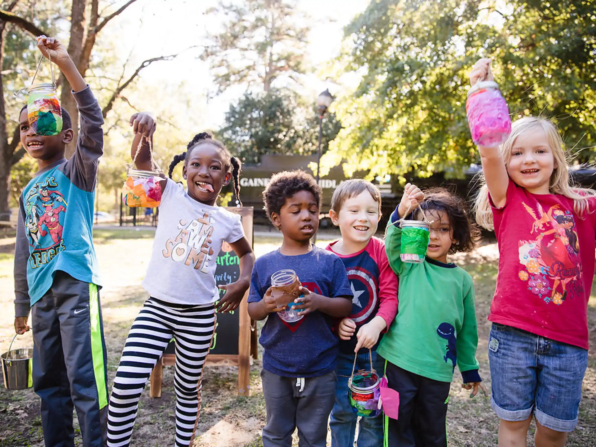 a group of children holding up their hands