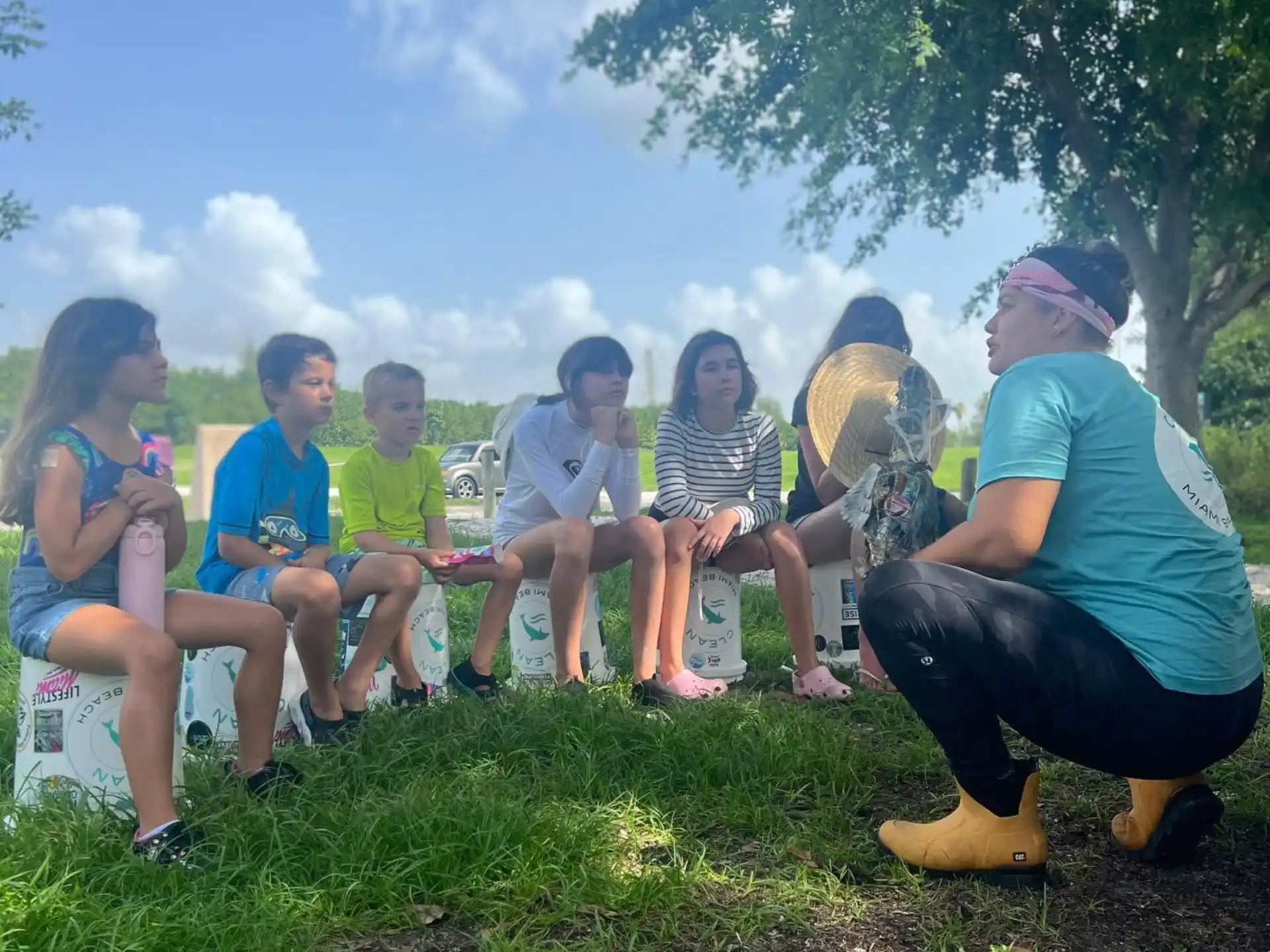 a group of people sitting on the grass