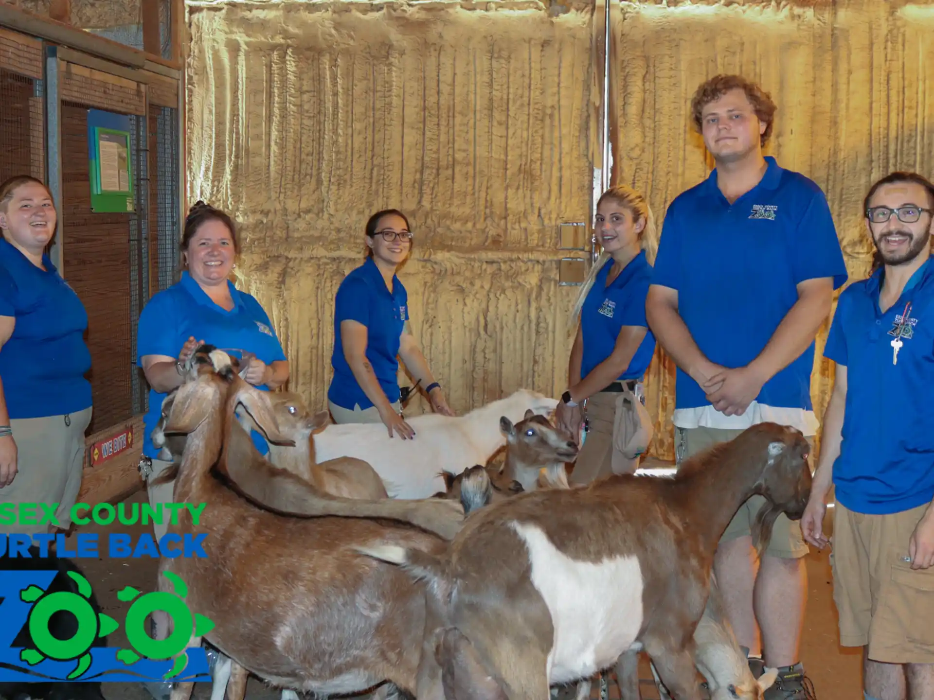 a group of people posing with animals