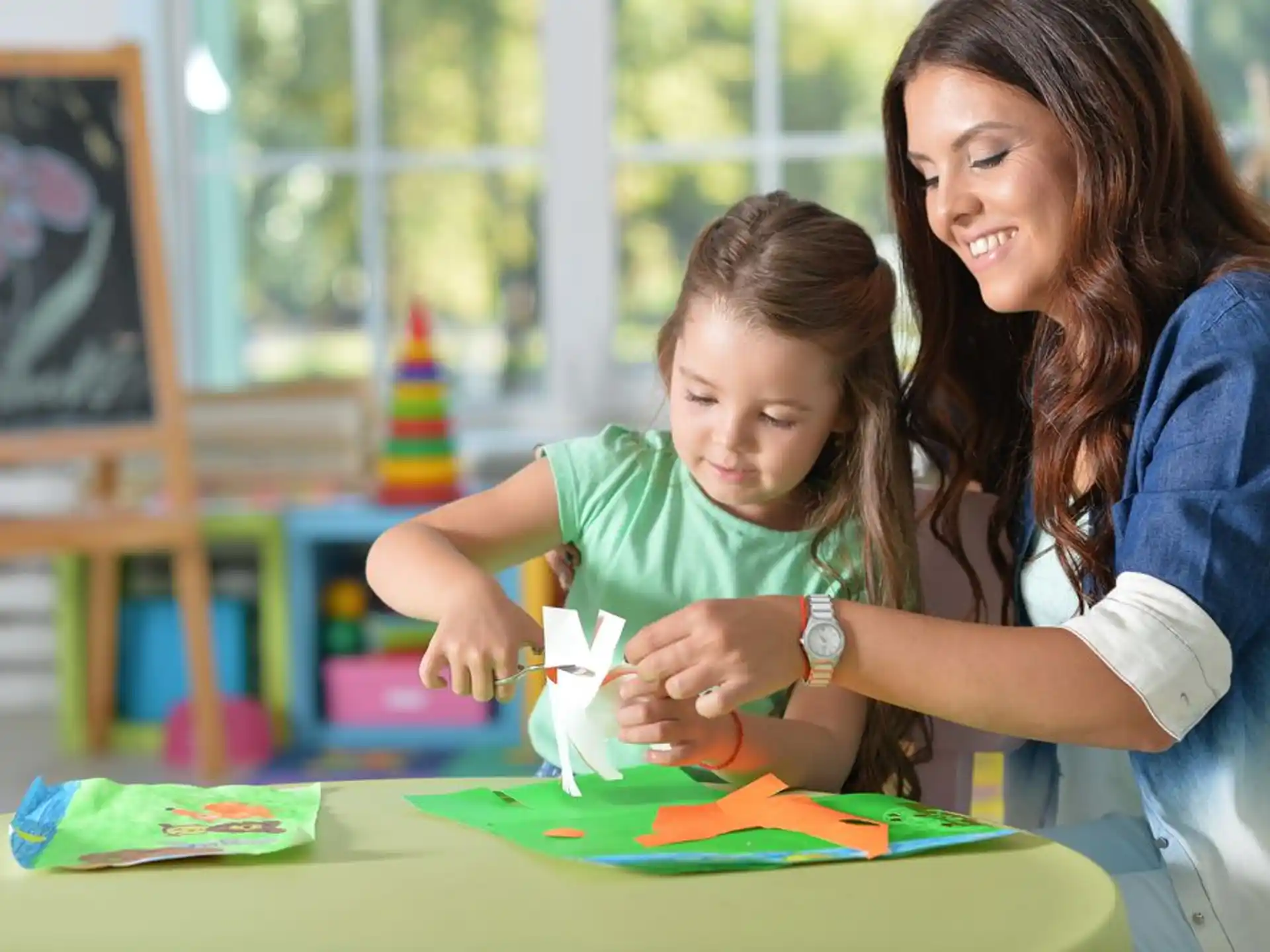 a person and a child playing with a toy