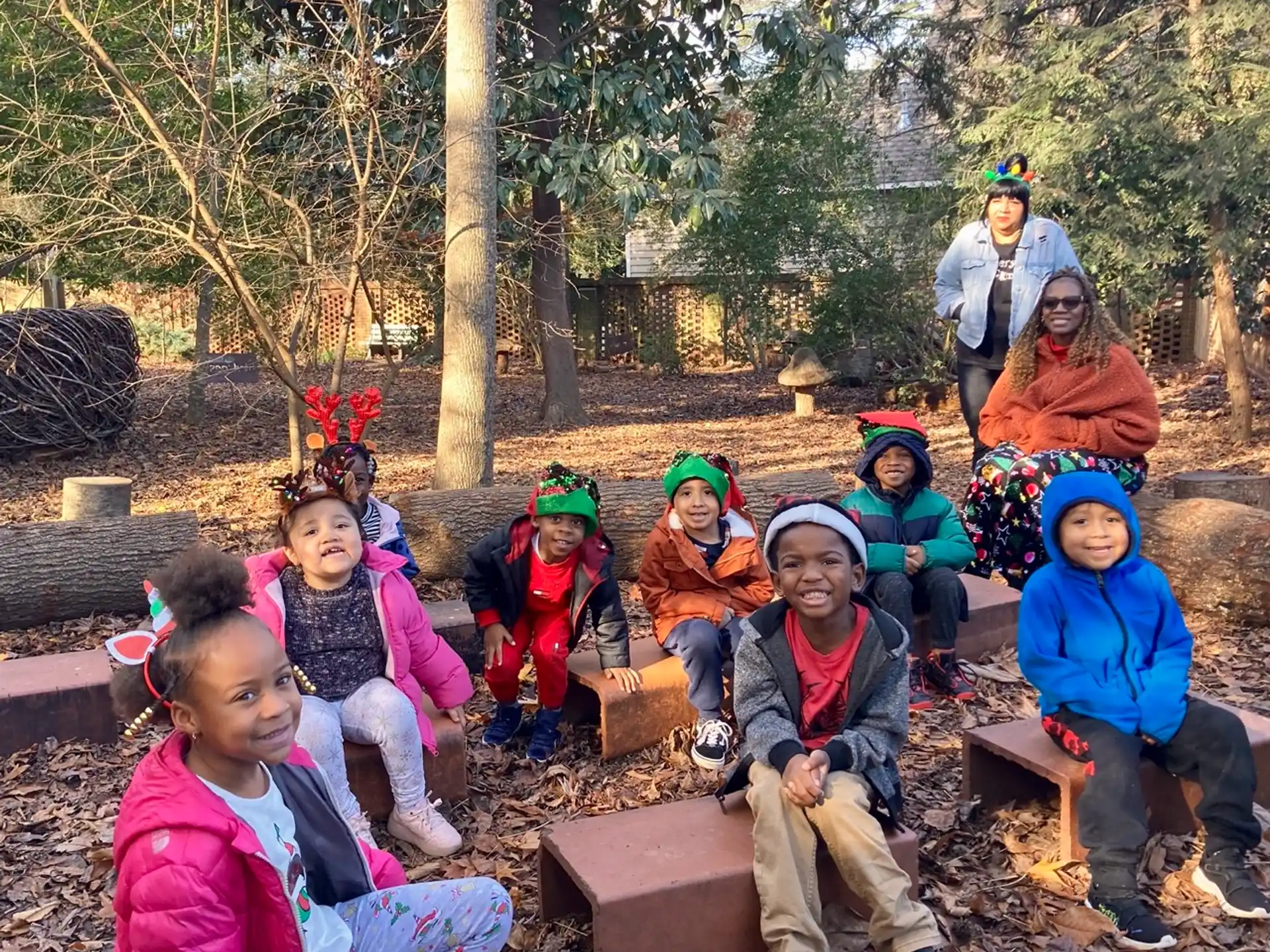 a group of people sitting on a bench in a park