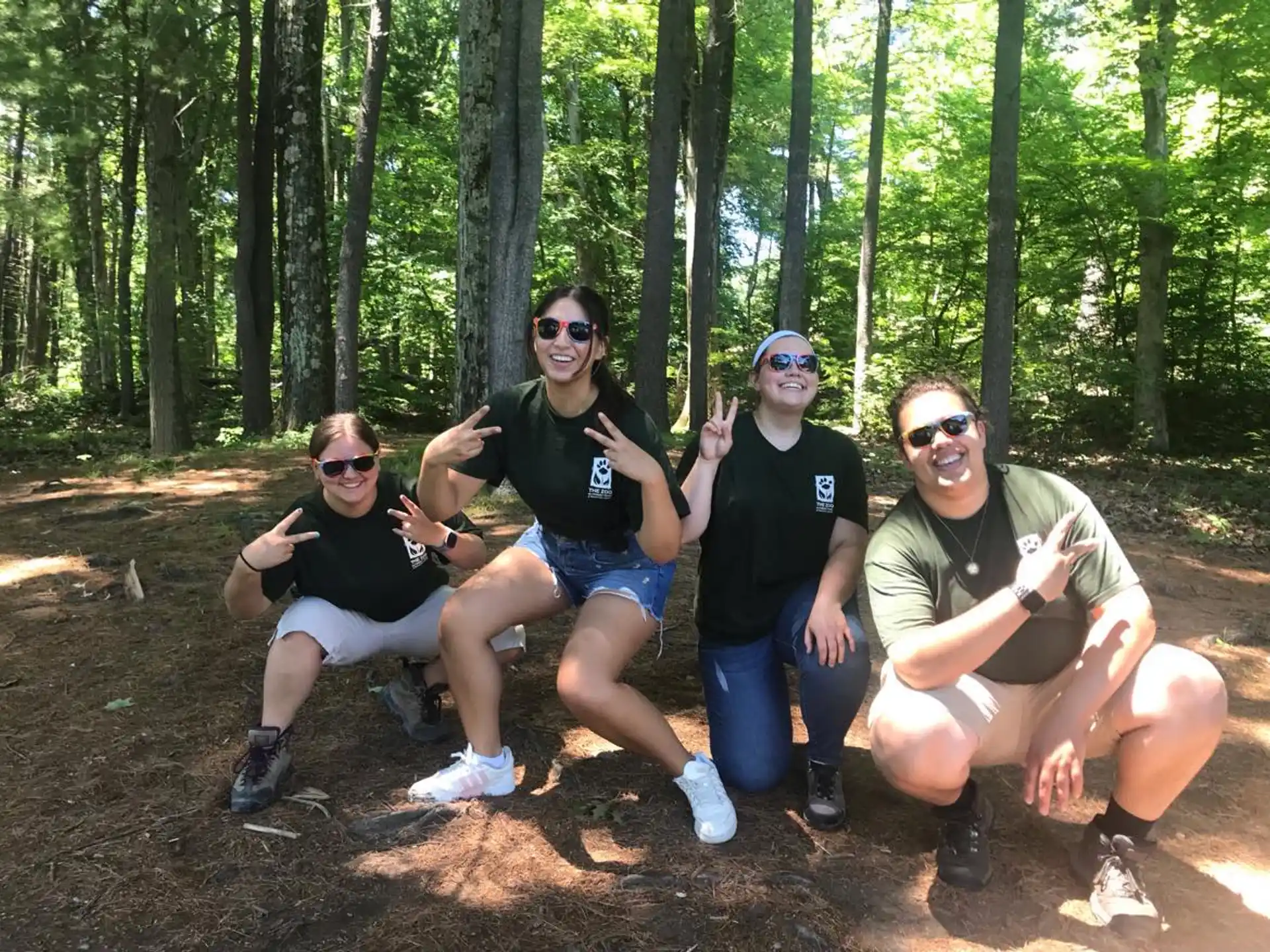 a group of people sitting in the woods