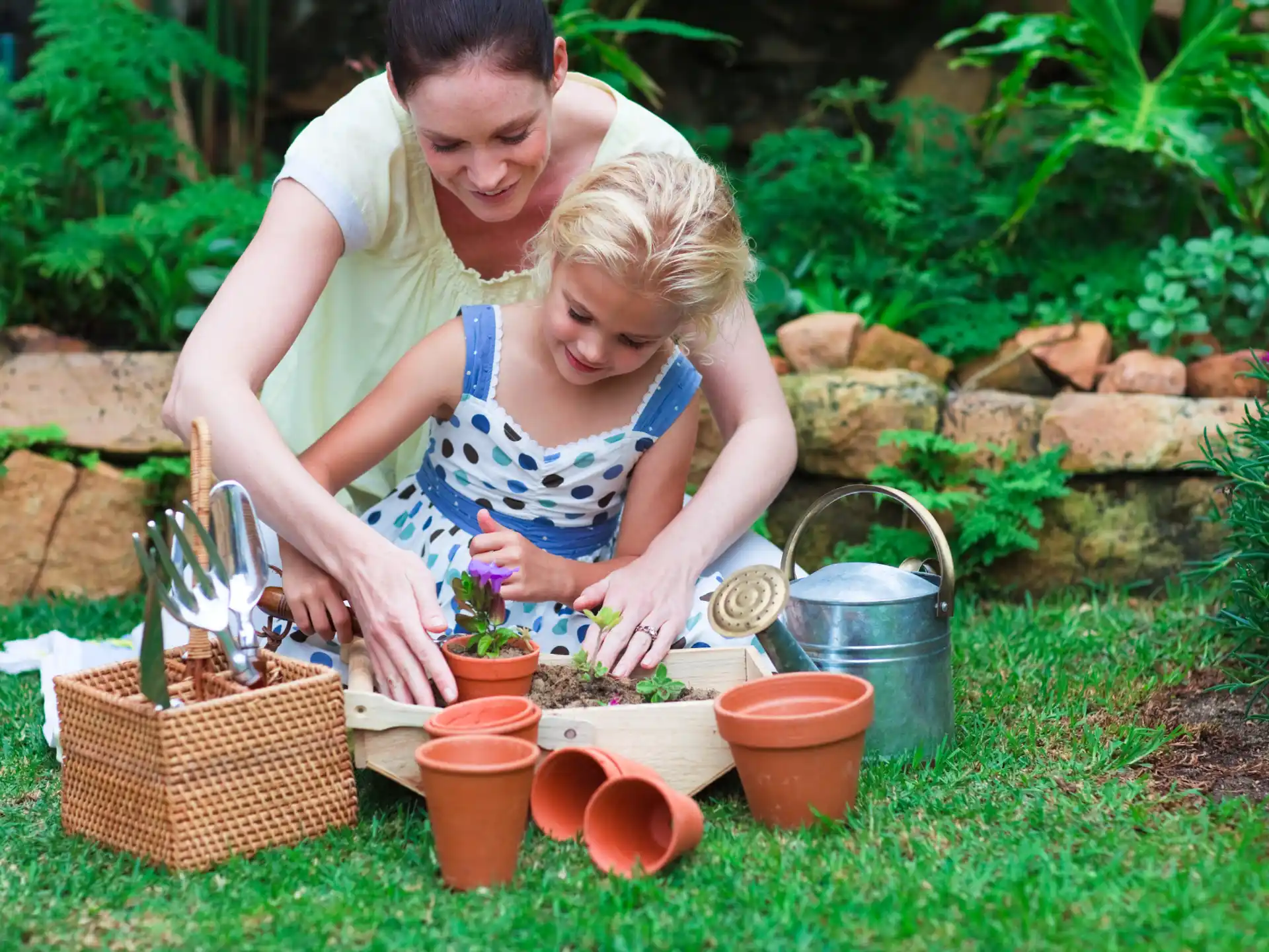 a person and a child planting plants