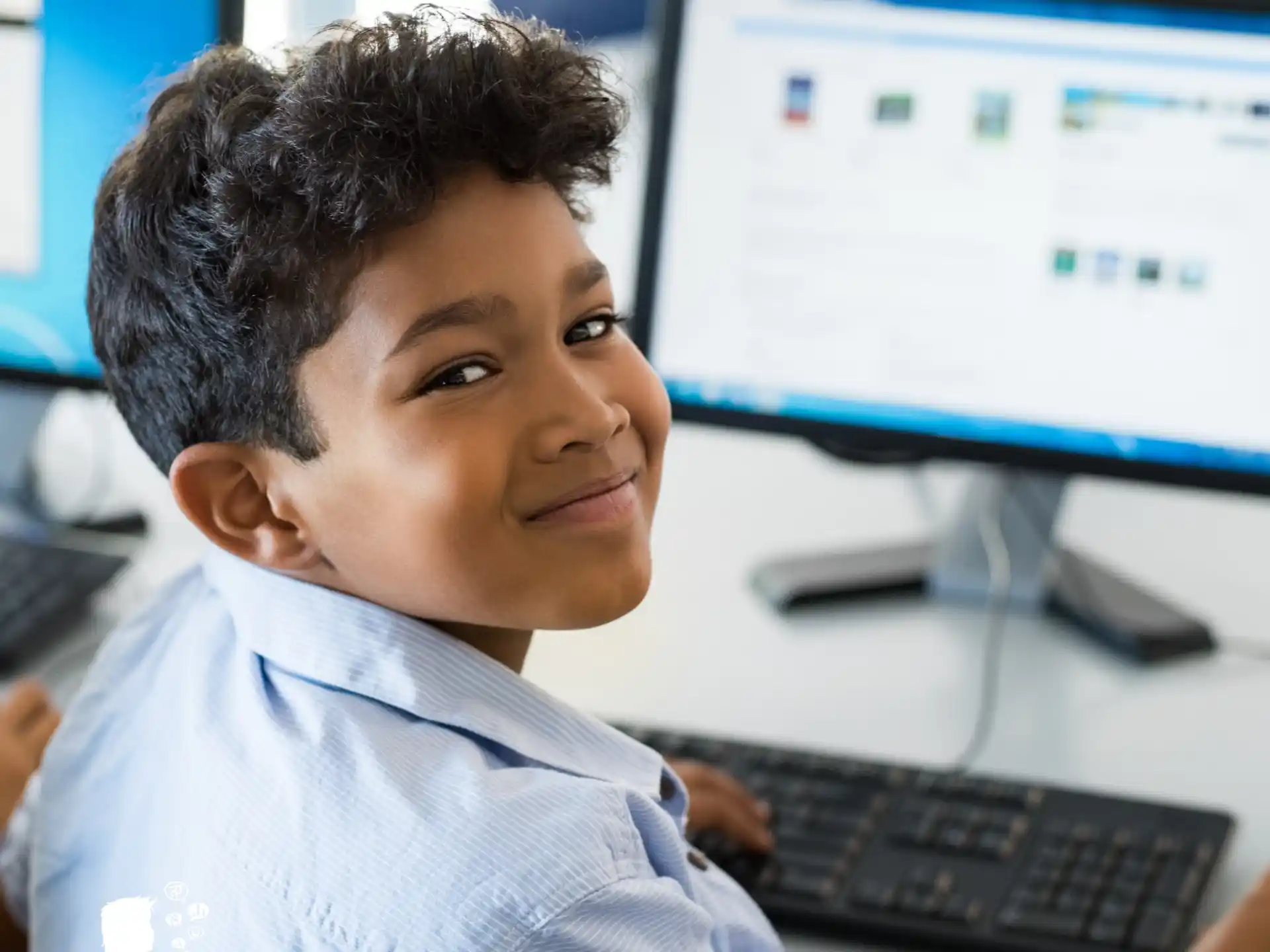 a young boy sitting at a computer