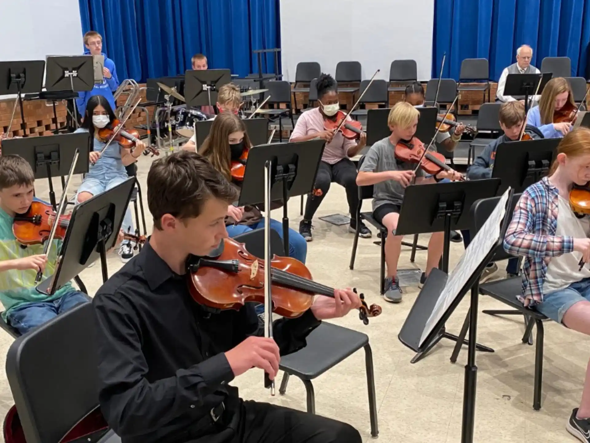 a group of kids playing instruments