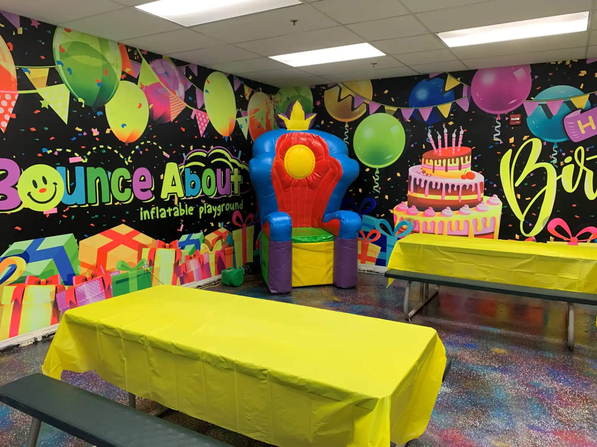 a room with a table and balloons