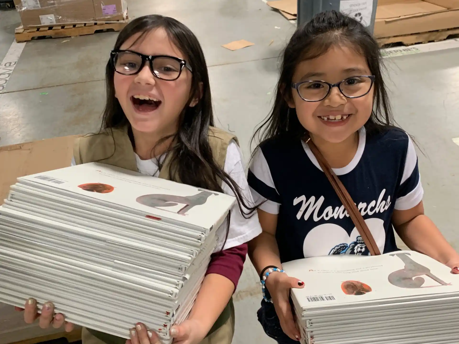a couple of girls holding boxes