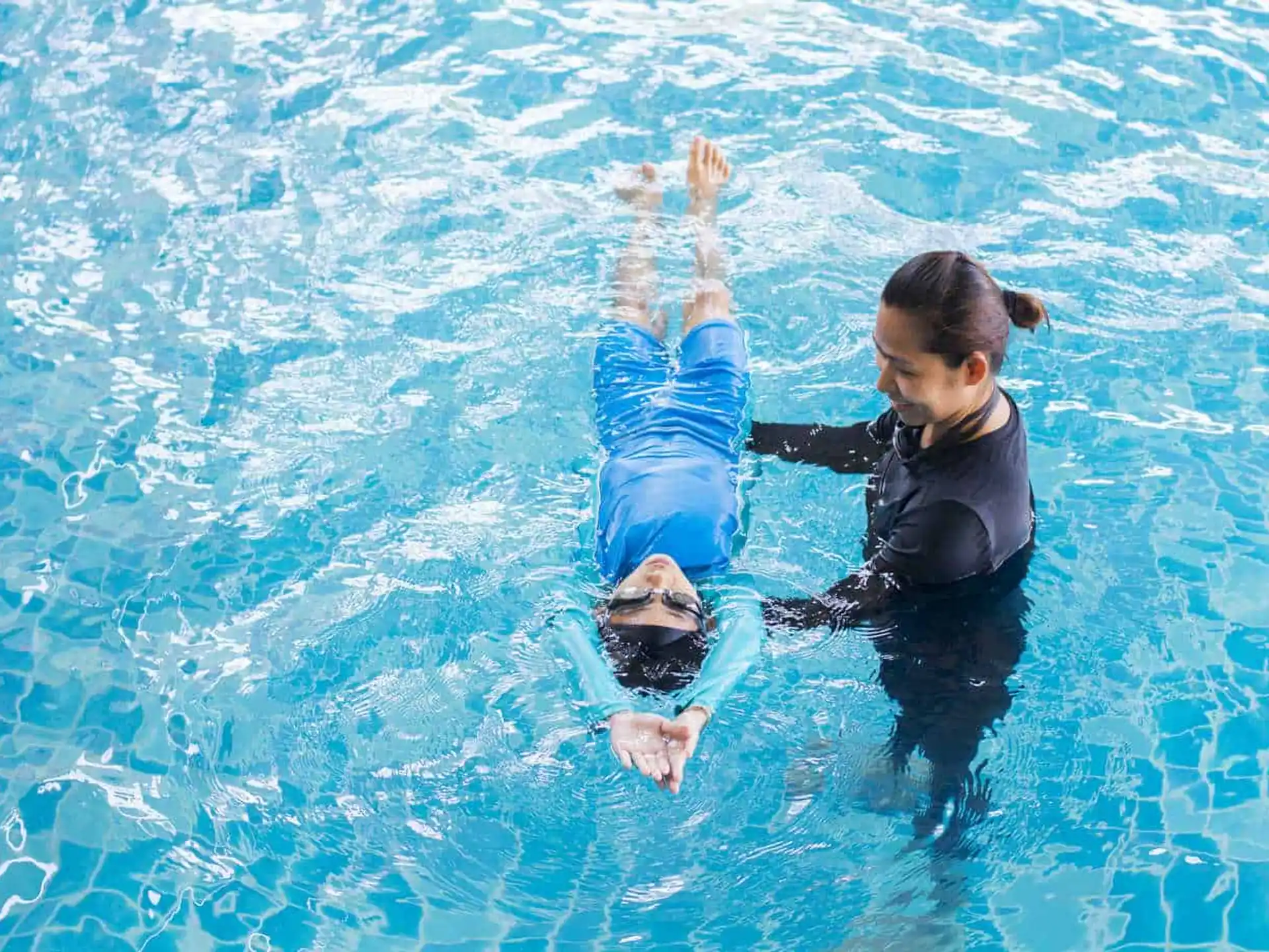 a man and a baby in a pool