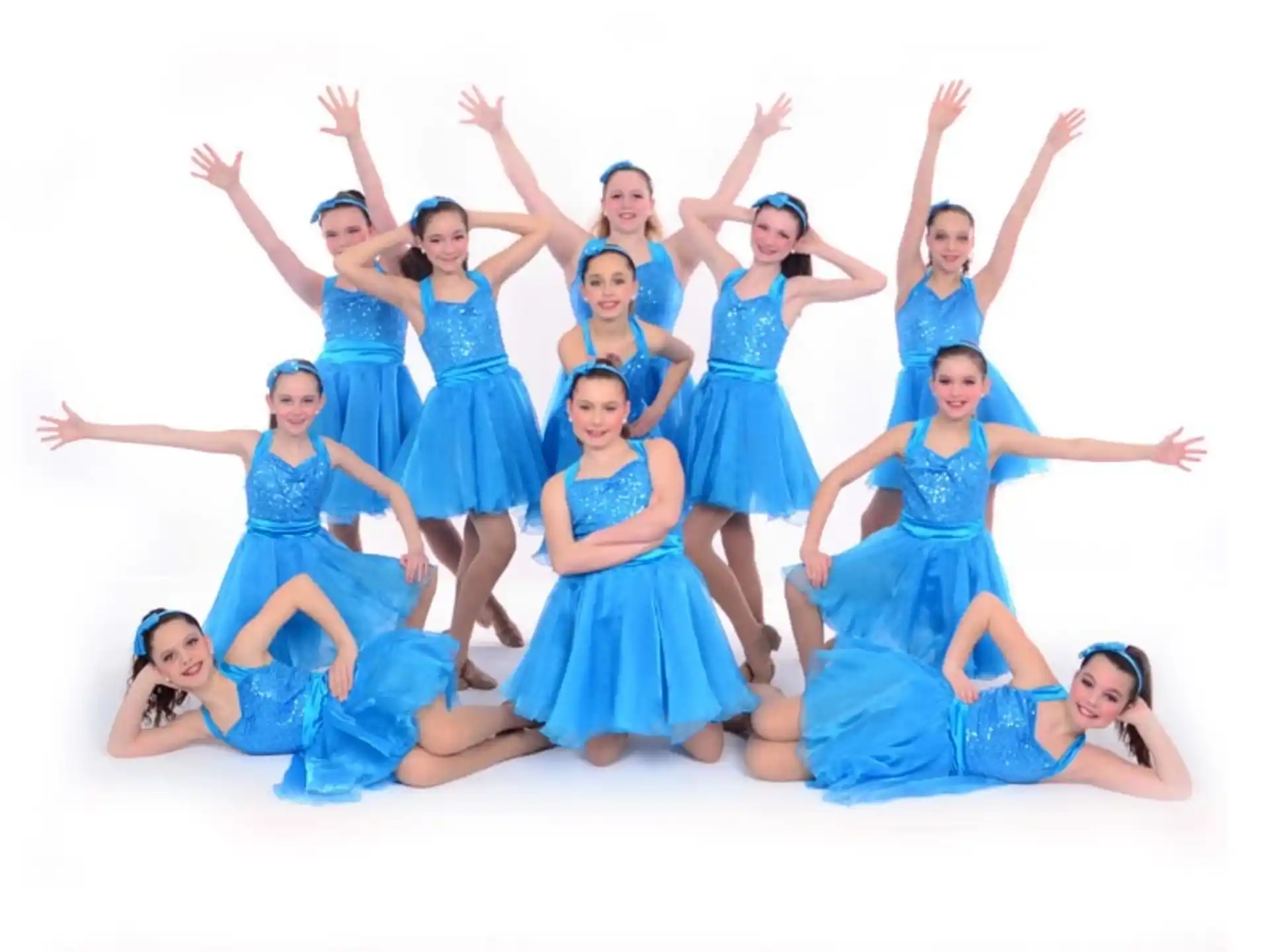 a group of women in blue dresses