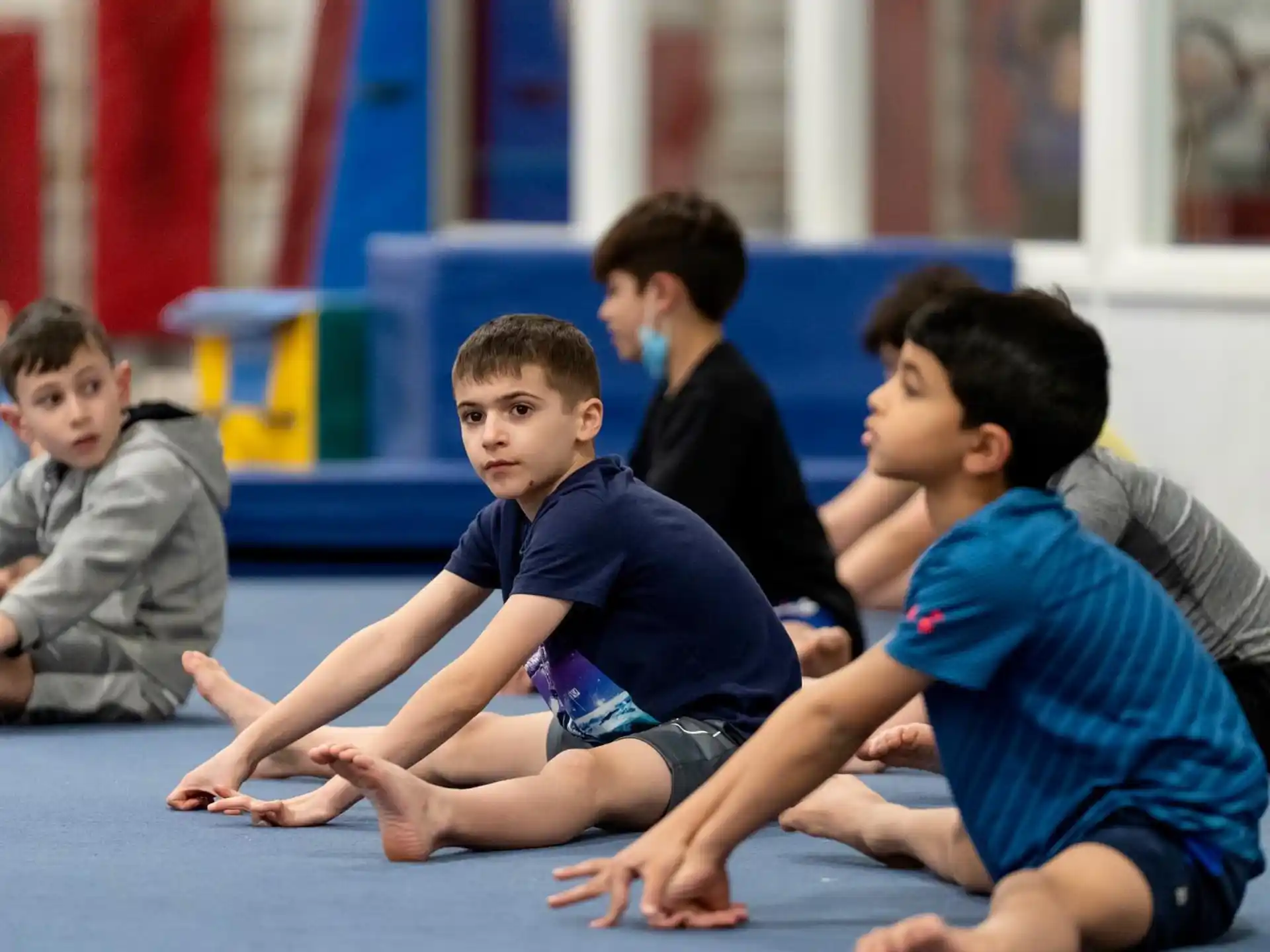 a group of boys sitting on the floor