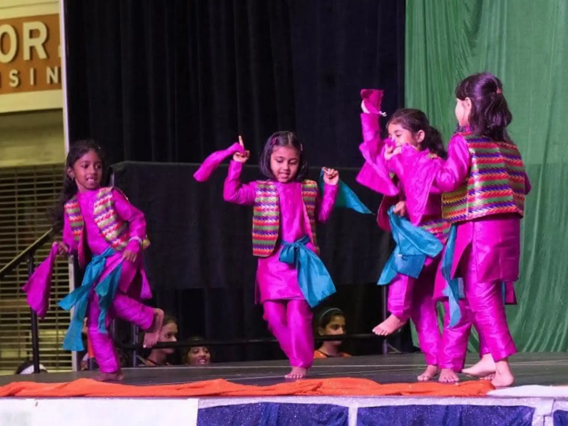 a group of children performing on a stage