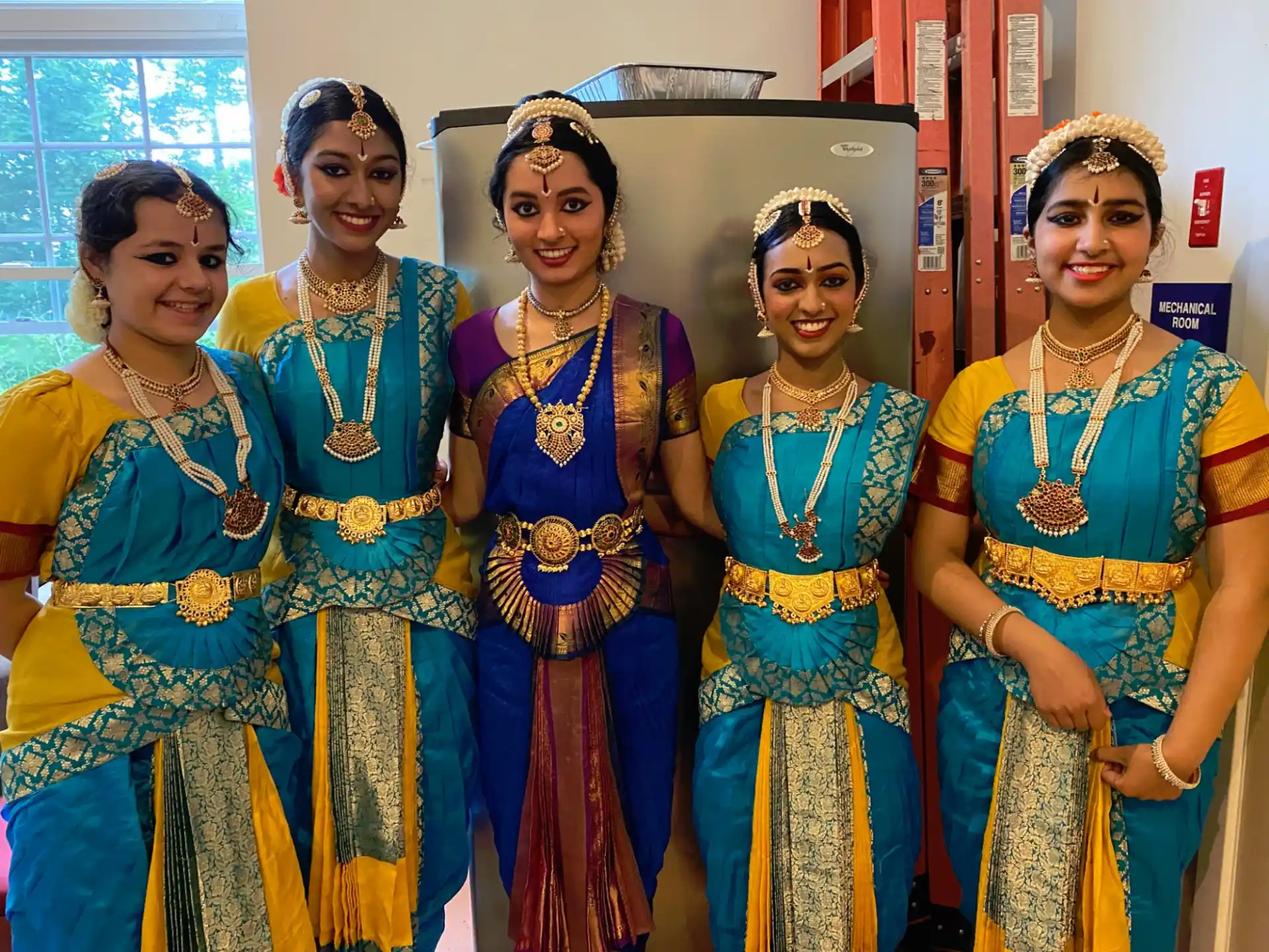 a group of women in colorful dresses