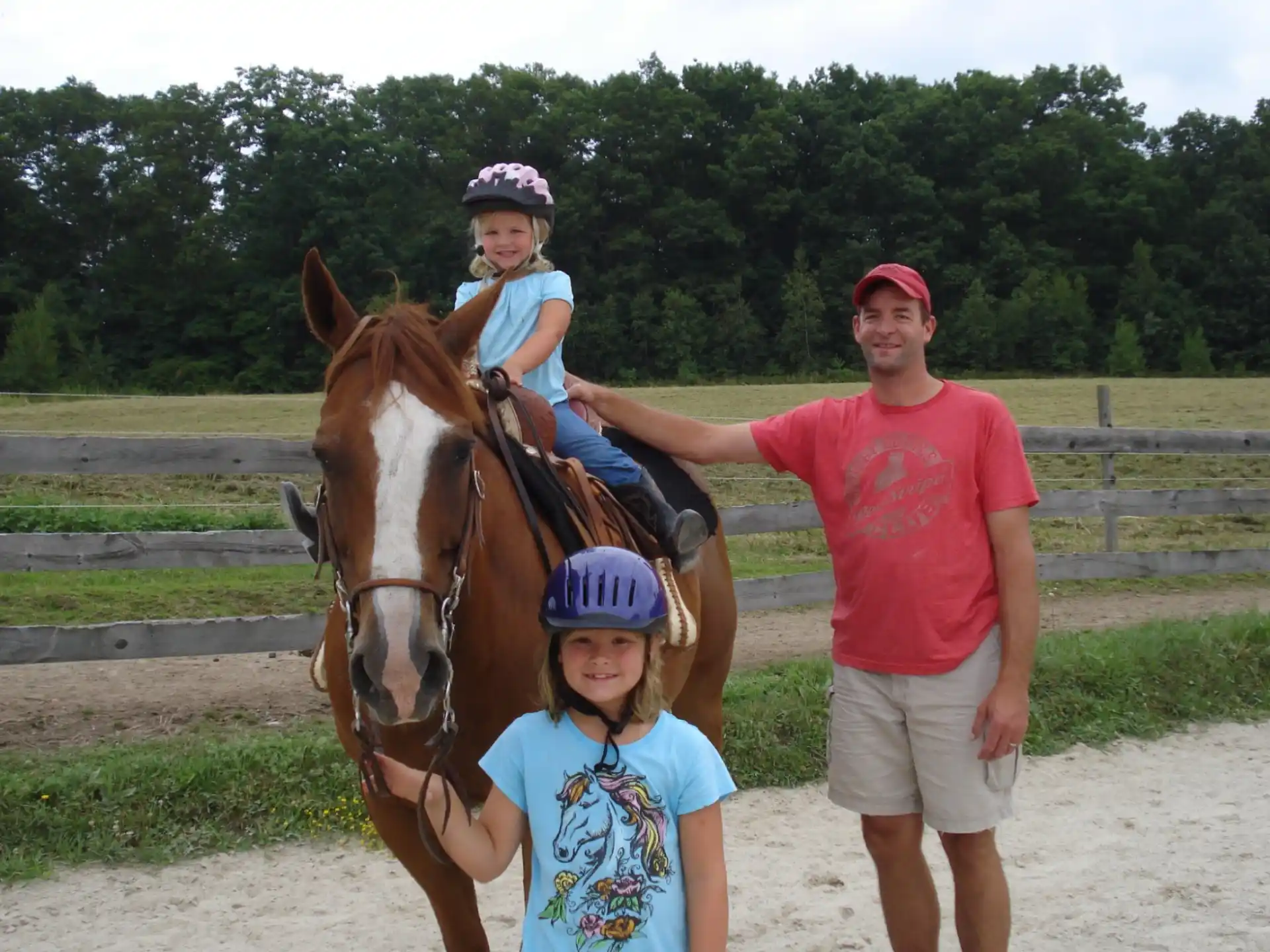 a person and a couple of children with a horse