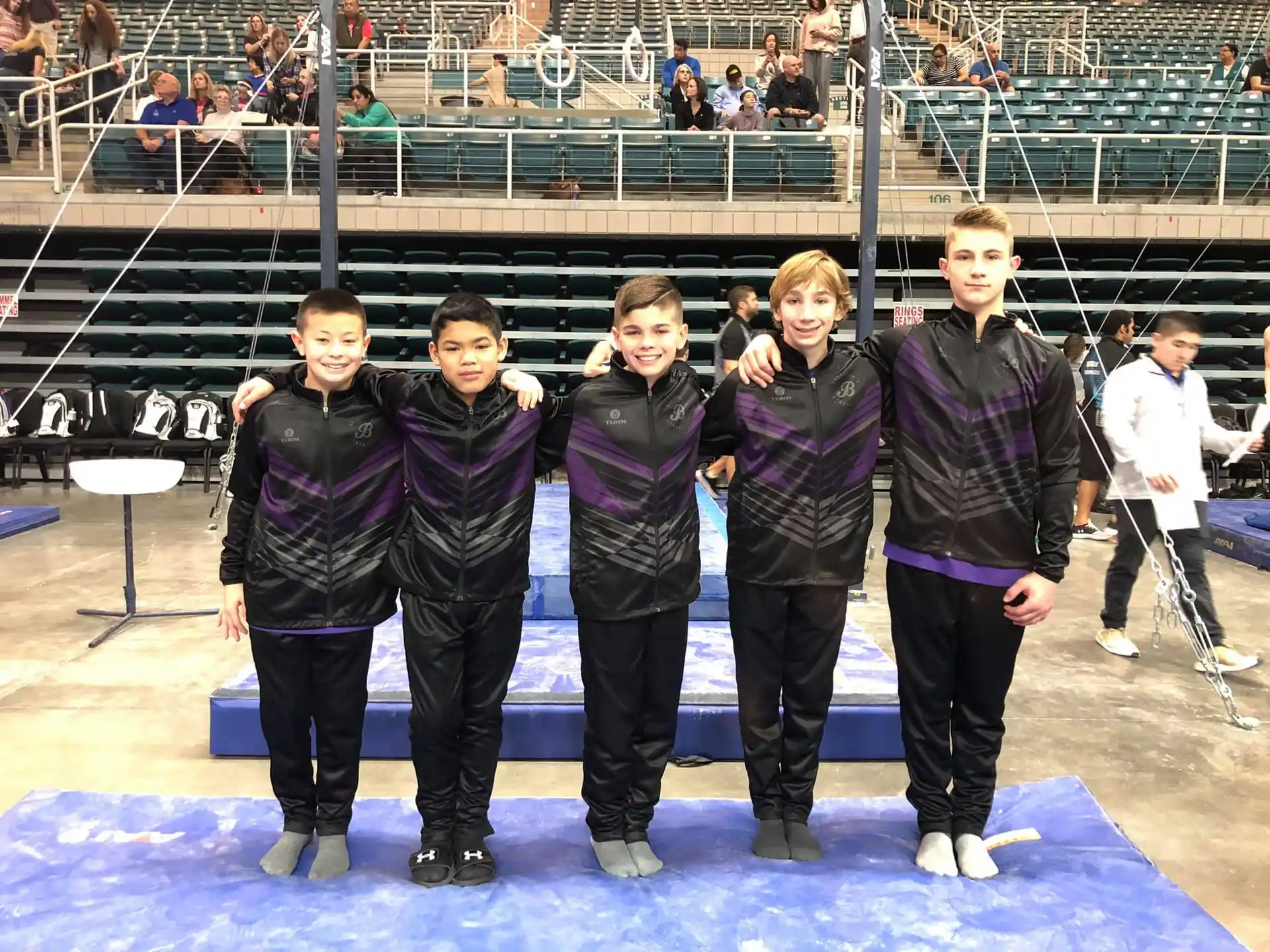 a group of people wearing ice skates posing for the camera
