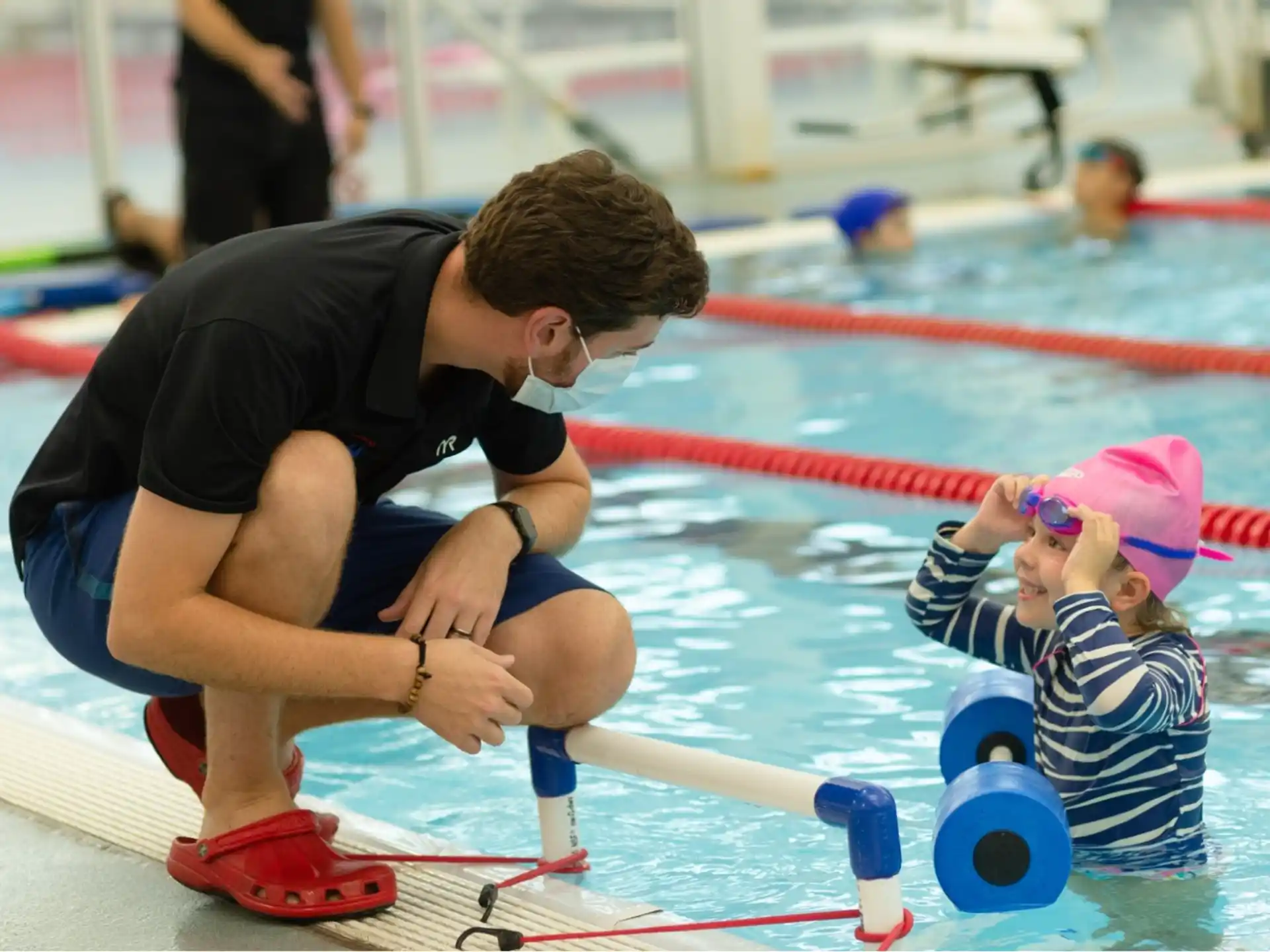 a person and a baby in a pool