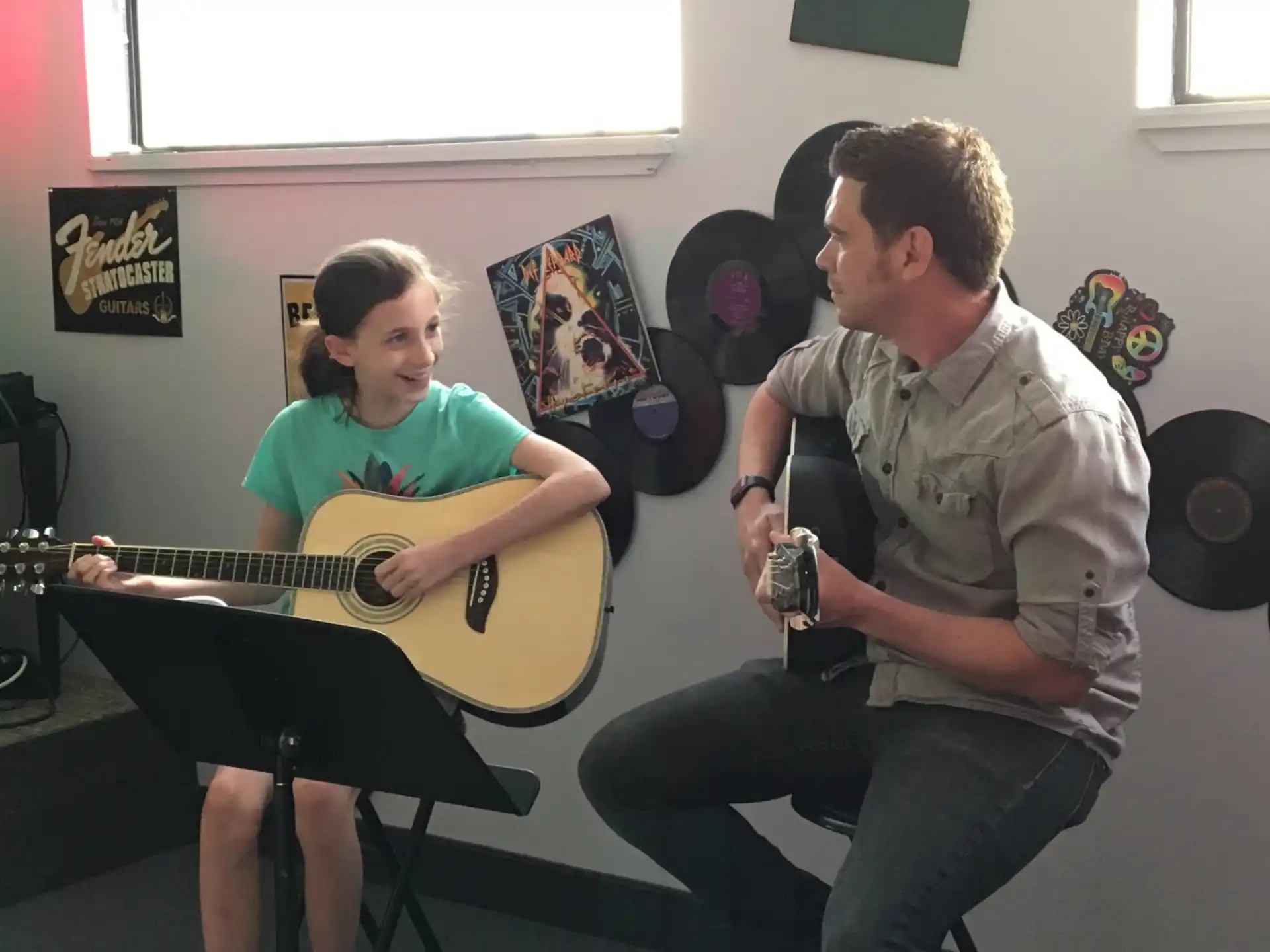 a group of people playing guitars