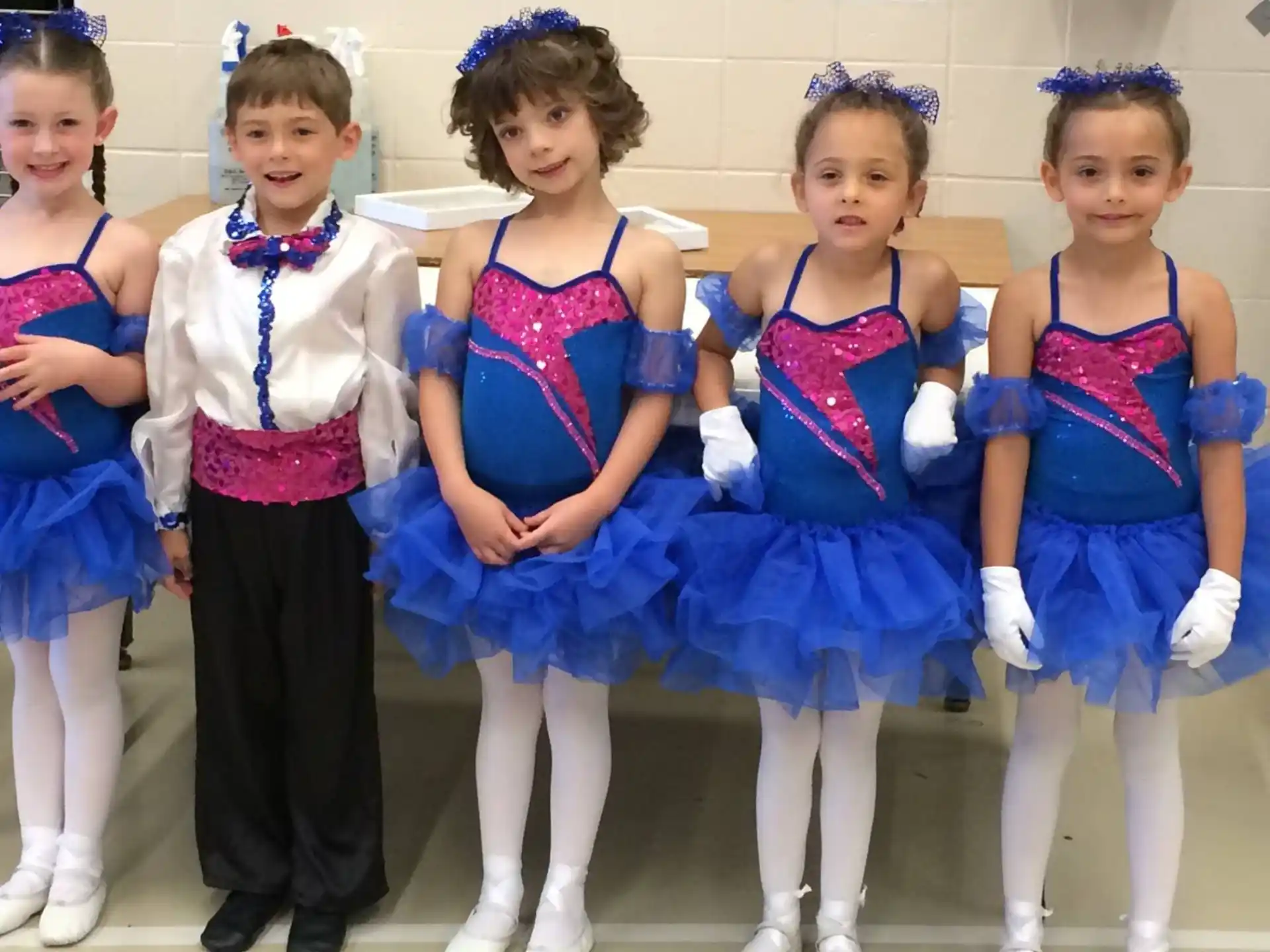 a group of girls in blue and white dresses