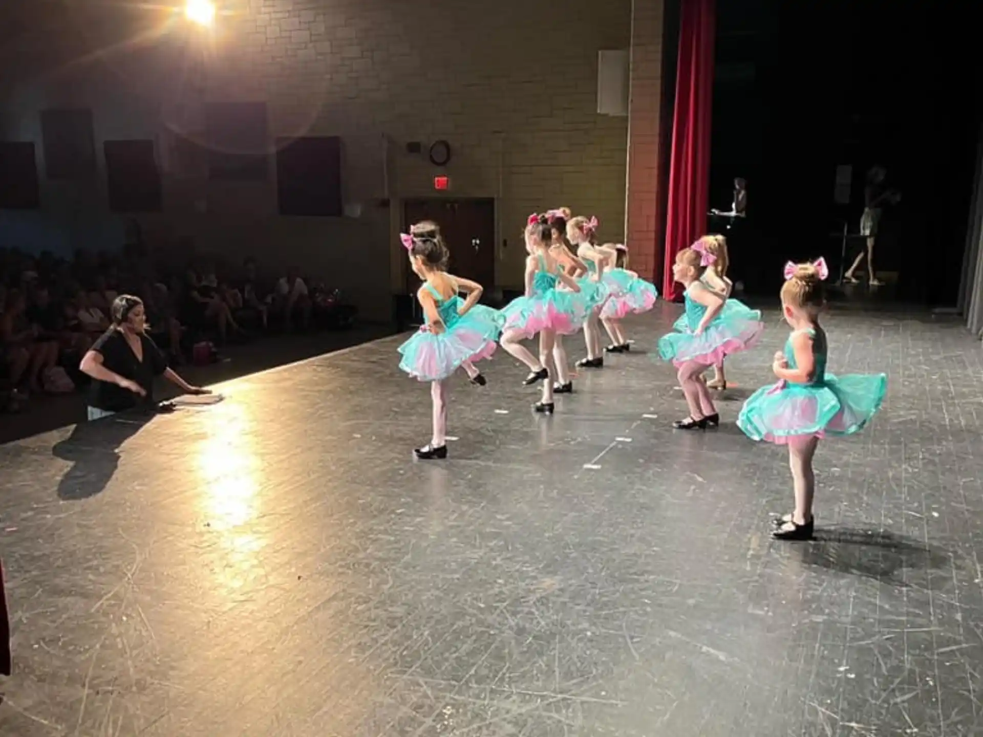 a group of girls dancing on a stage