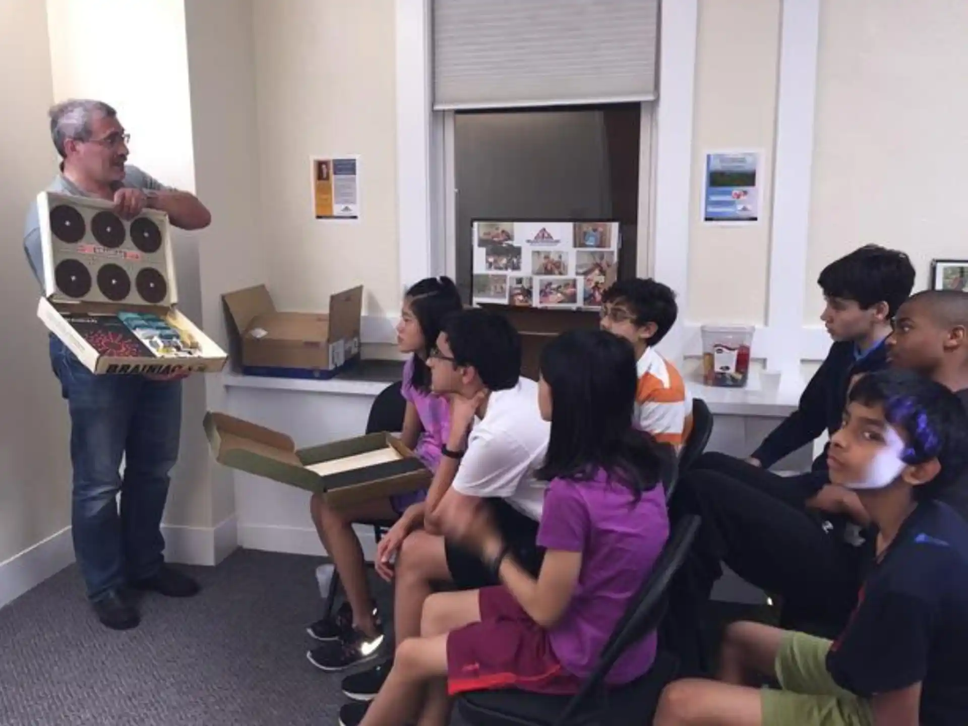 a group of people sitting in a classroom