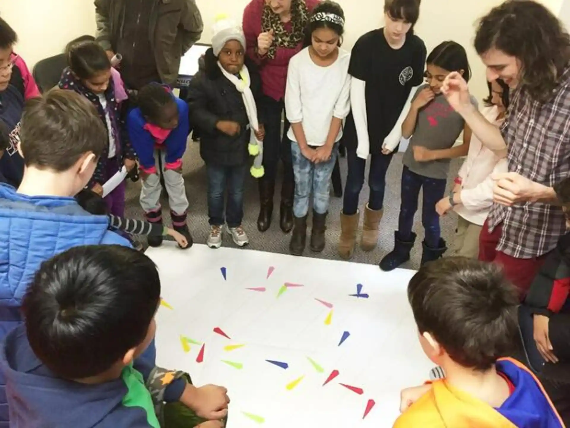 a group of people standing around a table with a map on it
