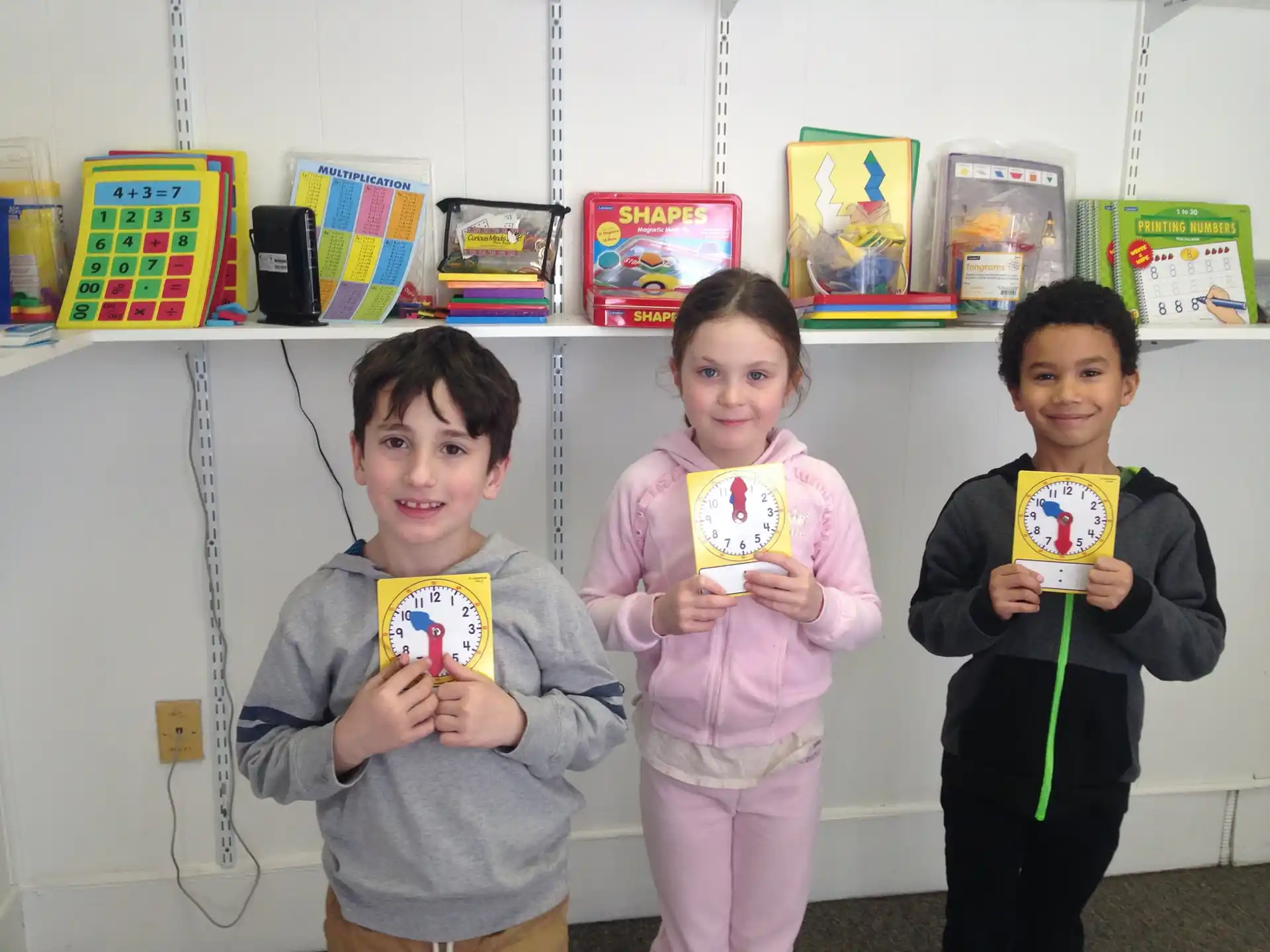 a group of children holding objects posing for the camera