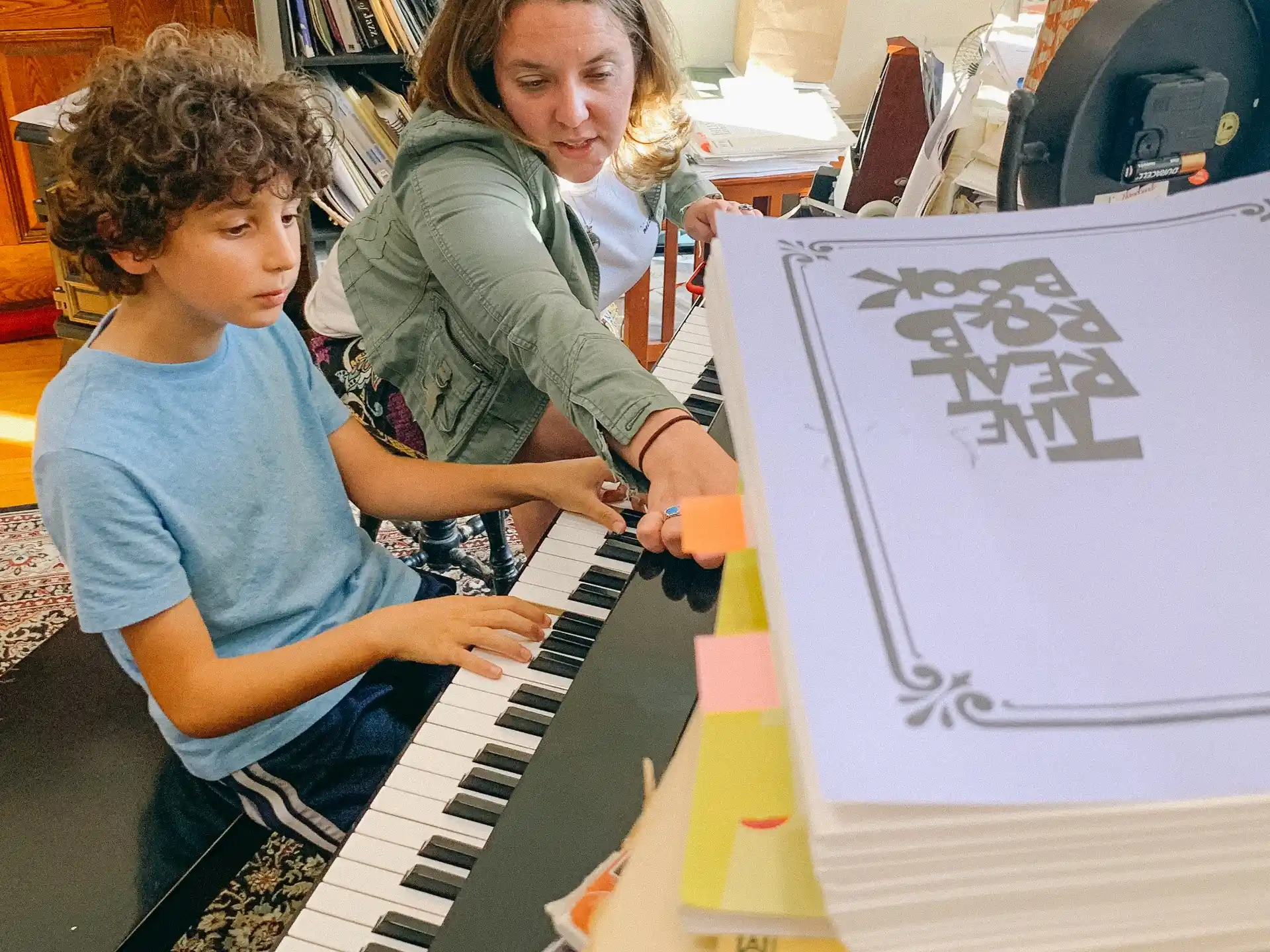 a couple of kids playing a piano
