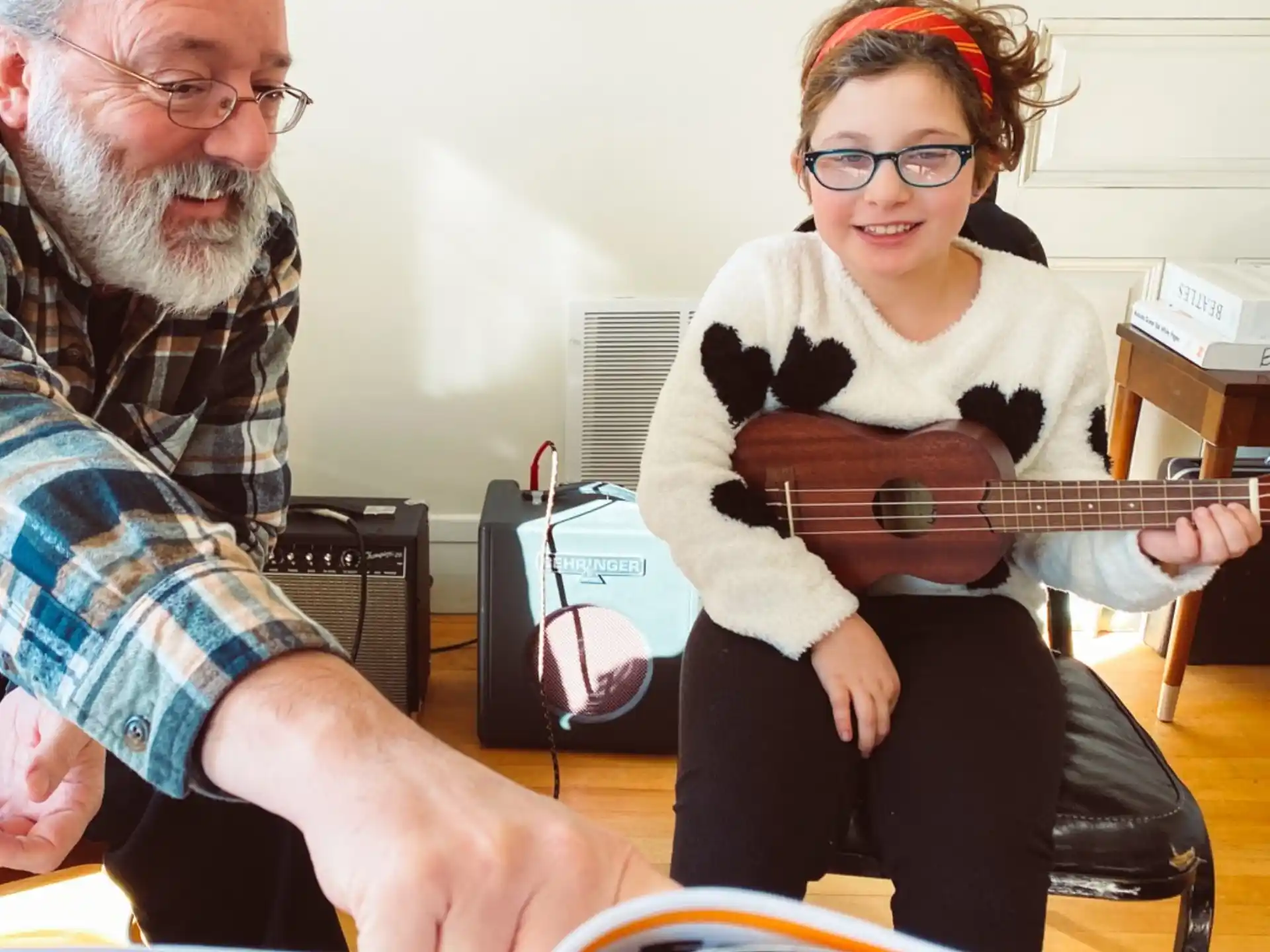 a man and a woman playing a guitar