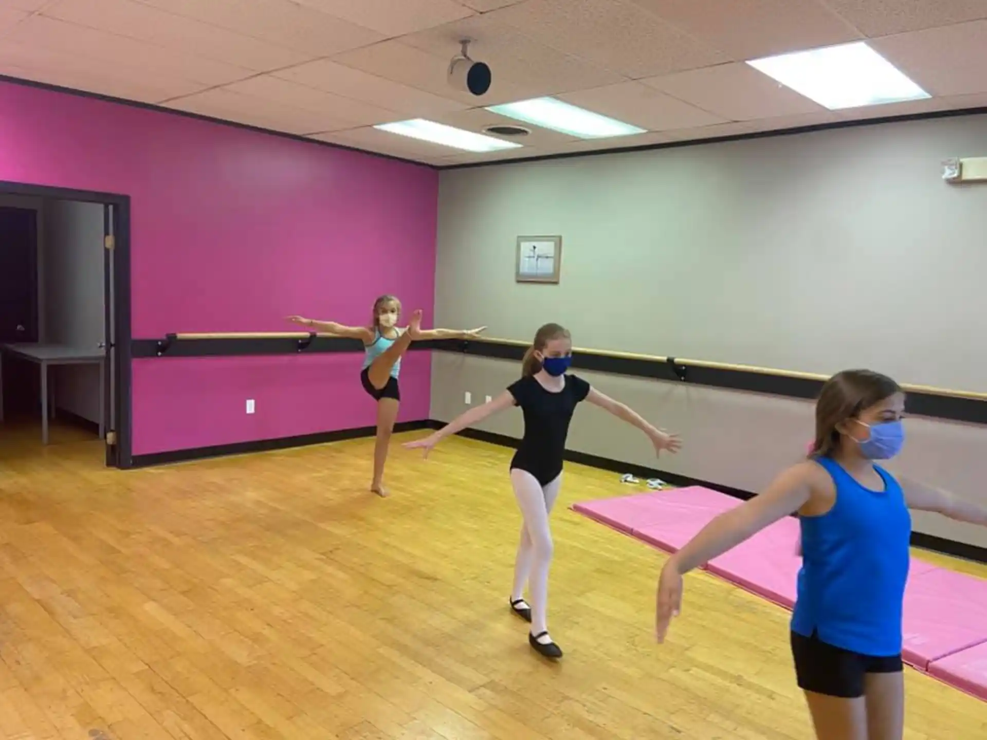 a group of women exercising in a room
