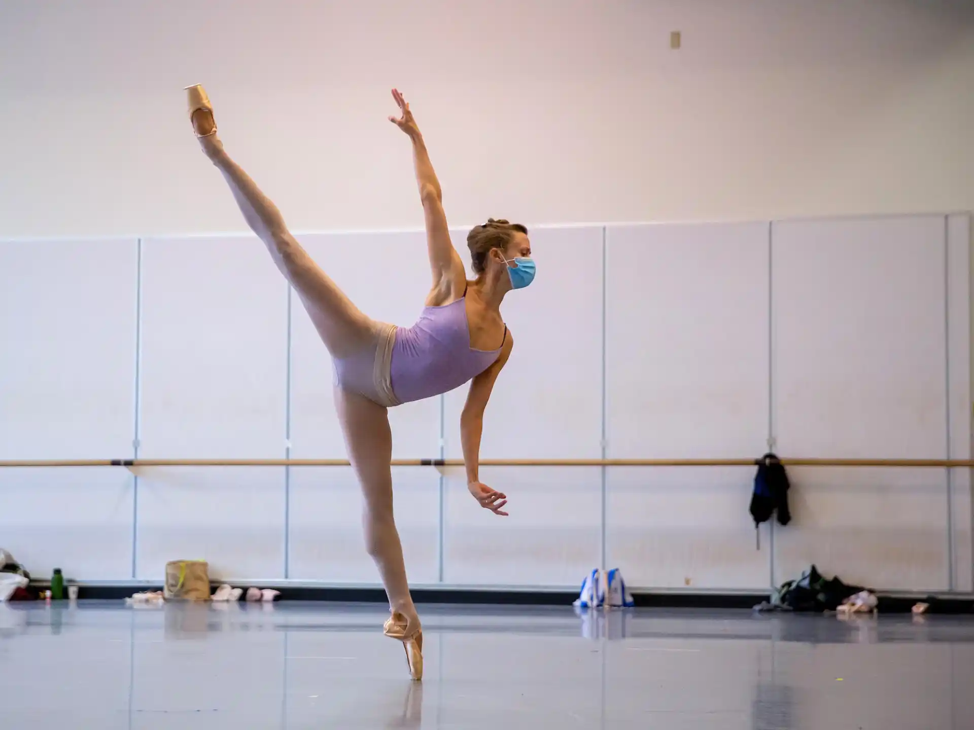 a woman in a leotard doing a handstand on a stage
